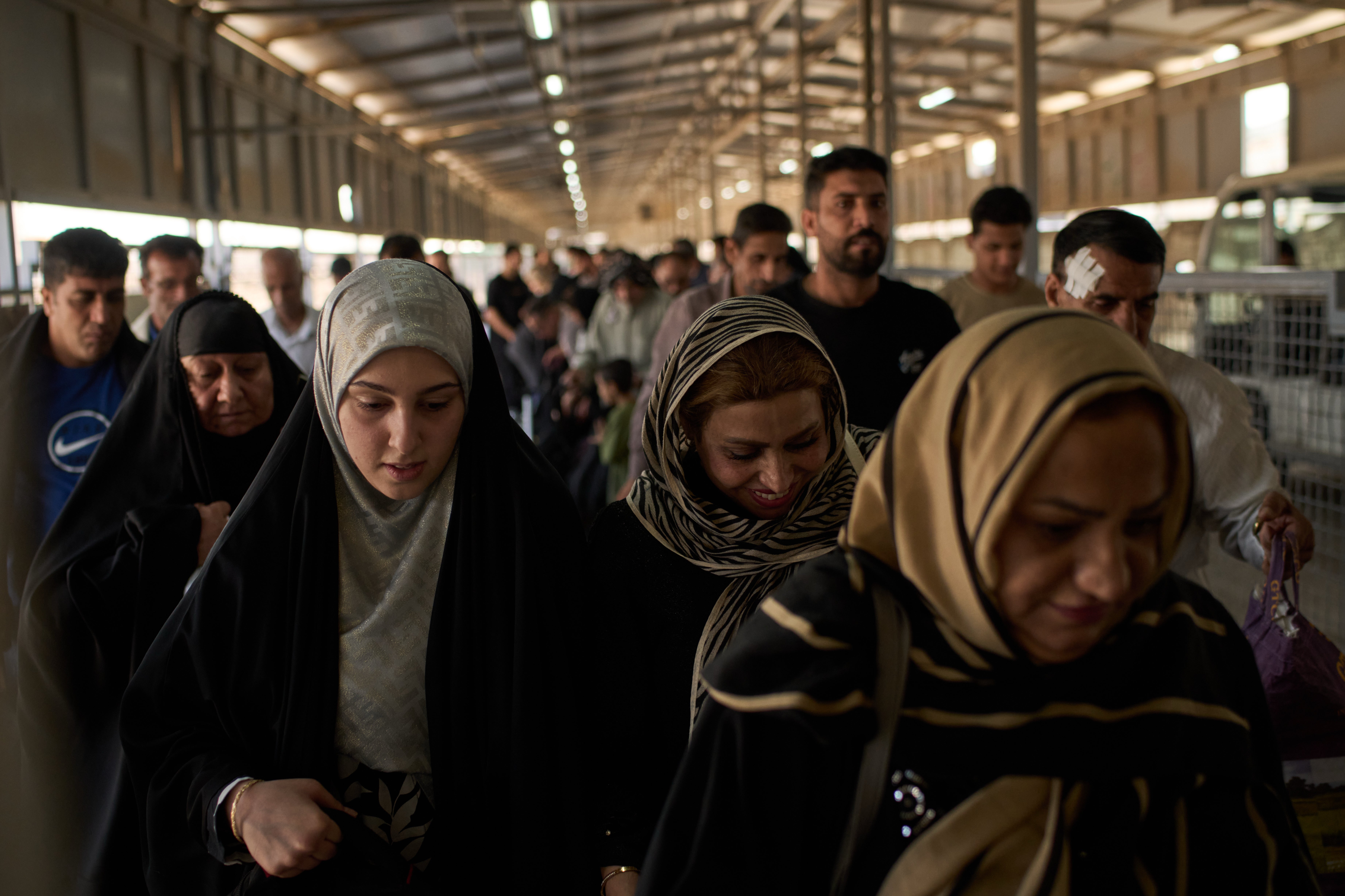 People who arrived from Iran cross the Shalamcheh border crossing between Iran and Iraq, near Basra, Iraq, Sunday, March 29, 2026. (AP Photo/Leo Correa)