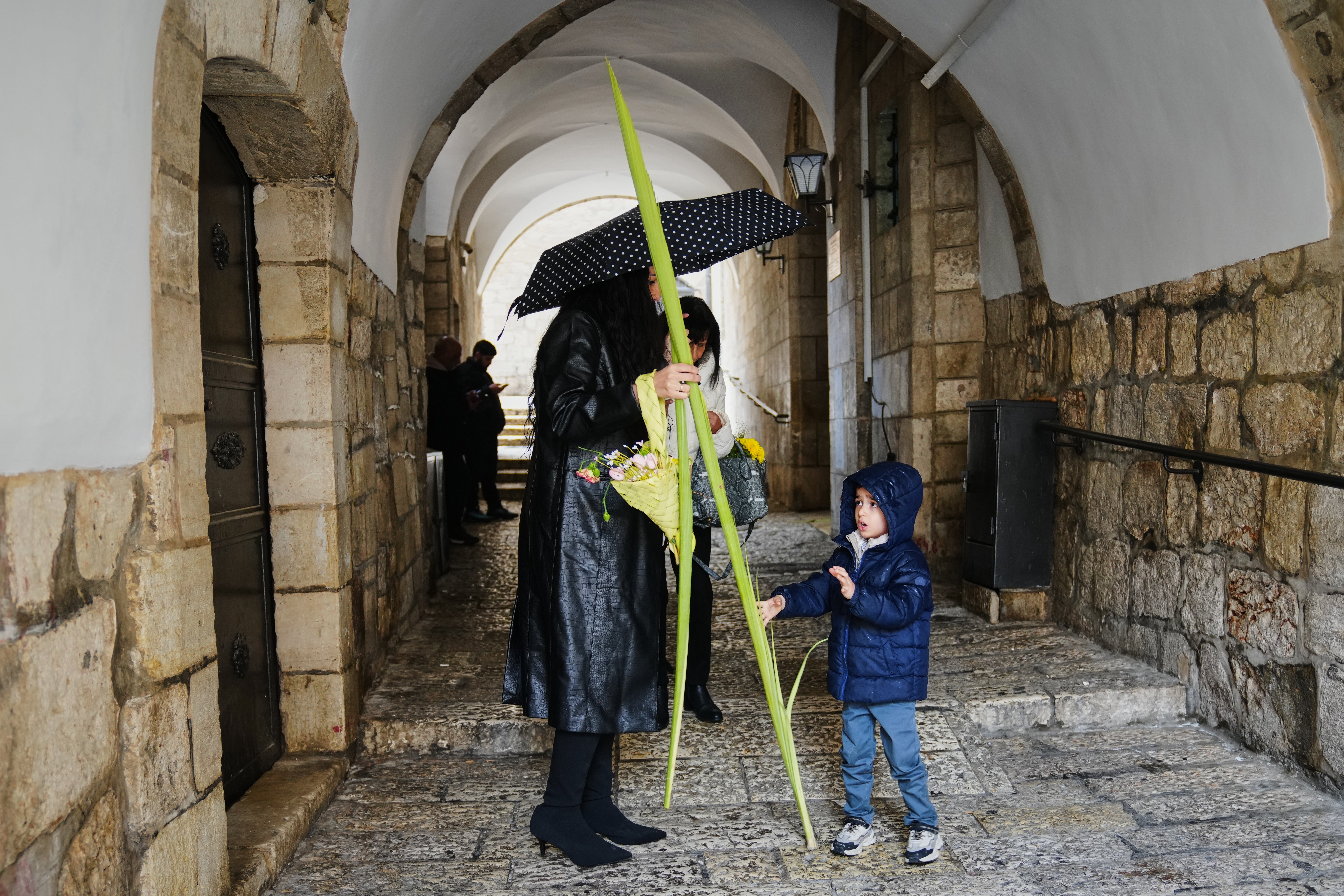 Christians walk with palm branches during Palm Sunday in Jerusalem's Old City, Sunday, March 29, 2026. (AP Photo/Mahmoud Illean)