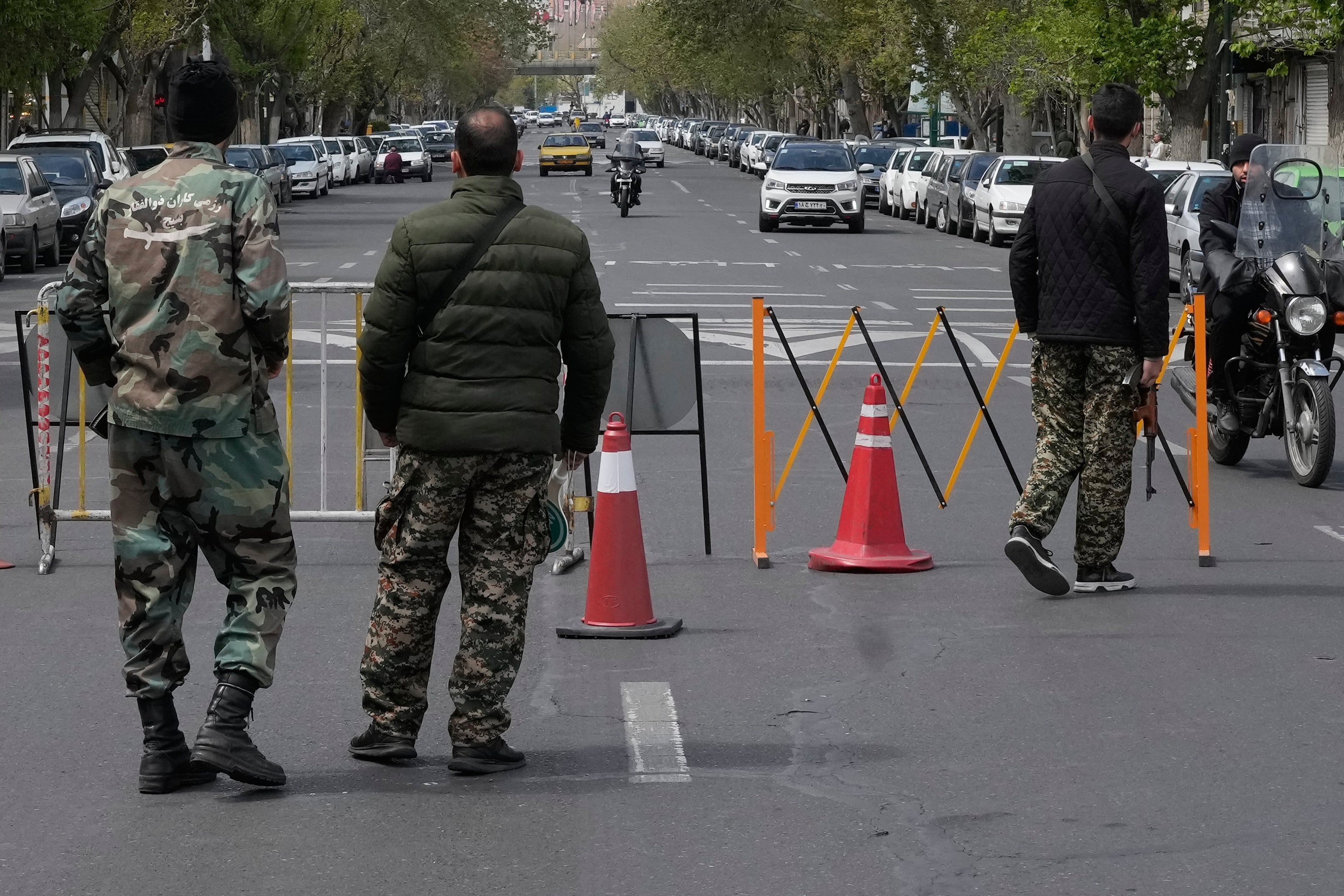 Members of the Basij paramilitary force stand at a checkpoint in Tehran, Iran, as residents report an increase in security crackdown.