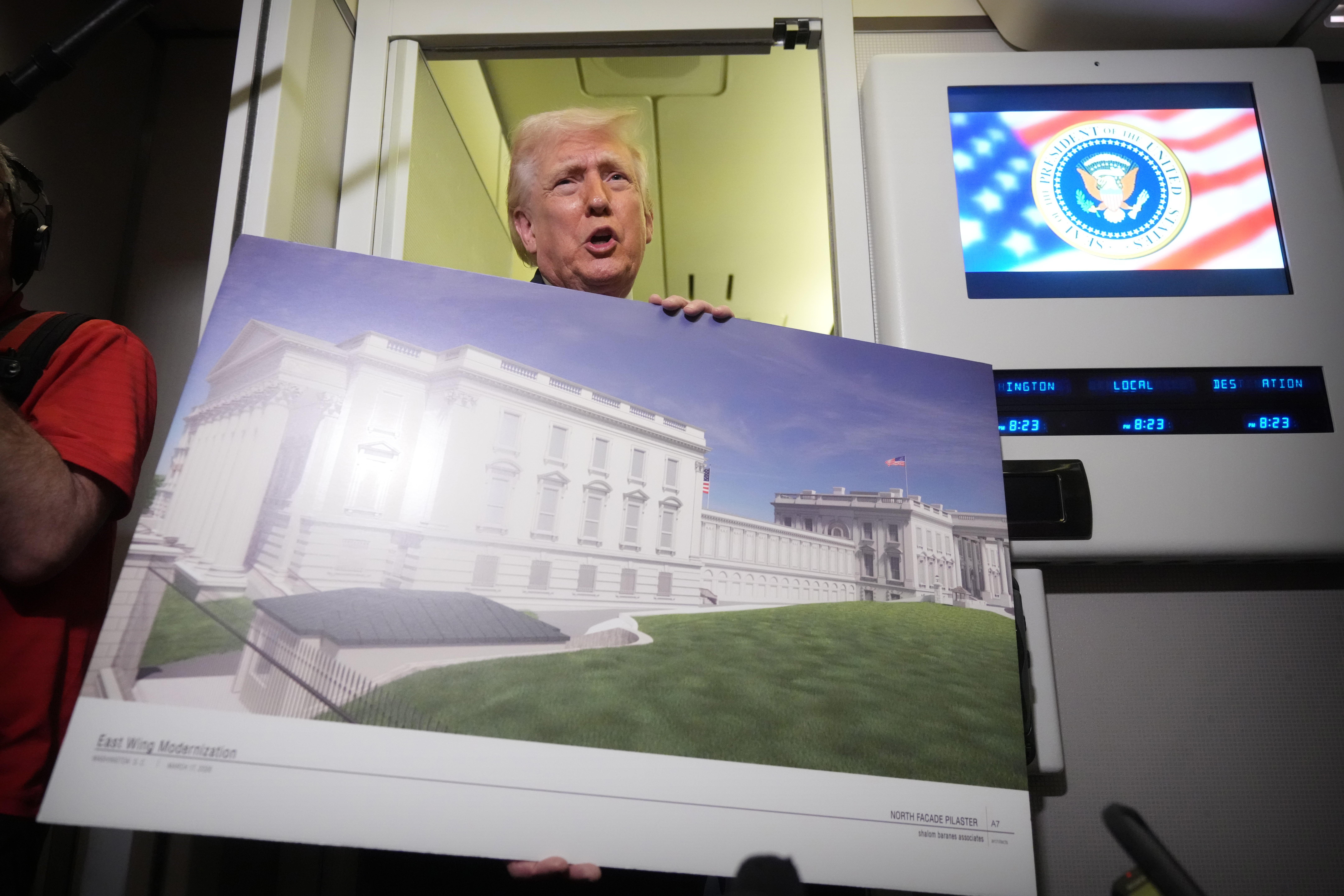 Trump brought out large posters showing a rendering of his $400 million White House ballroom while on Air Force One to defend the project