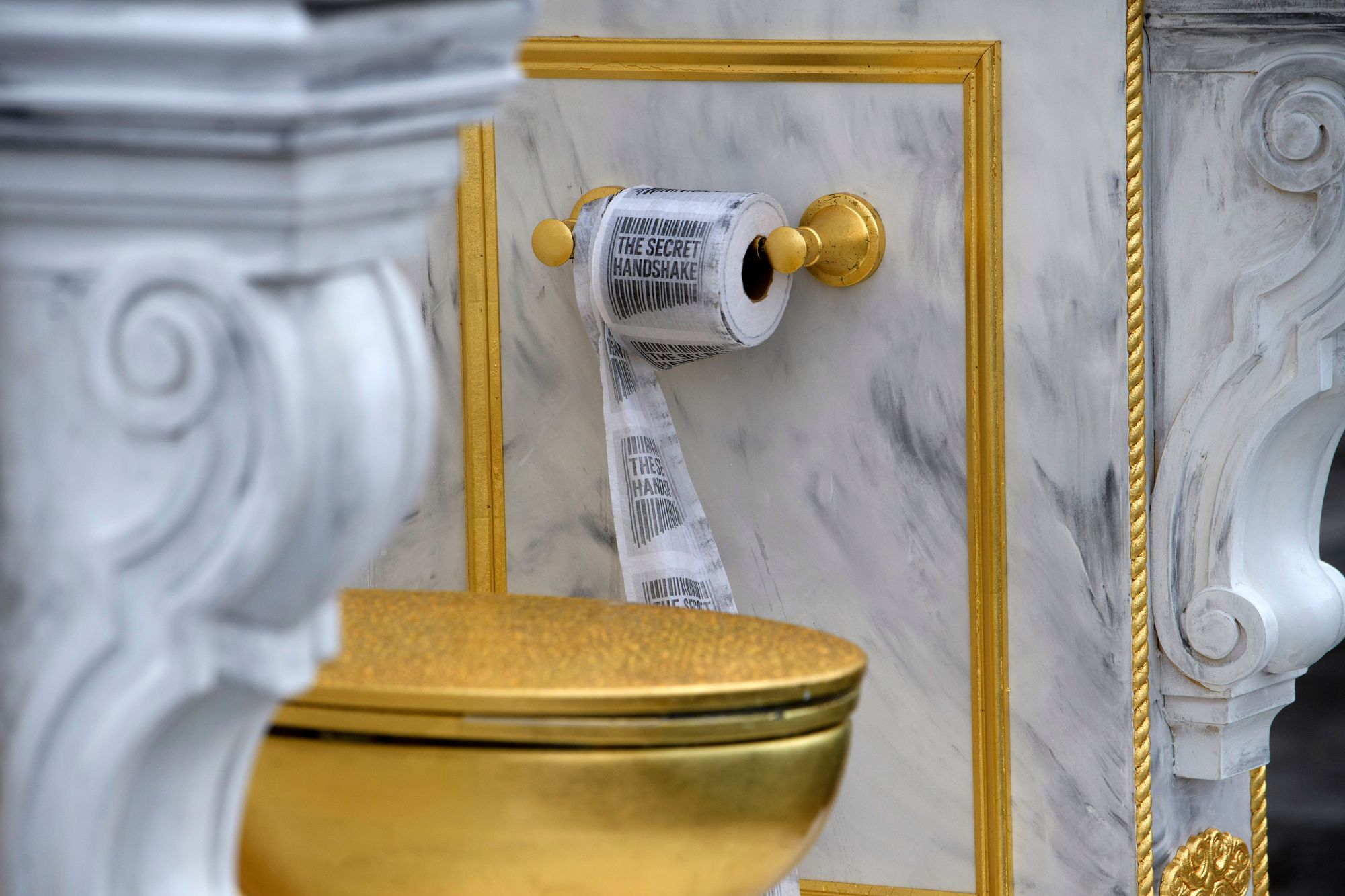 The Secret Handshake added its logo to the toilet paper featured in the new installation piece