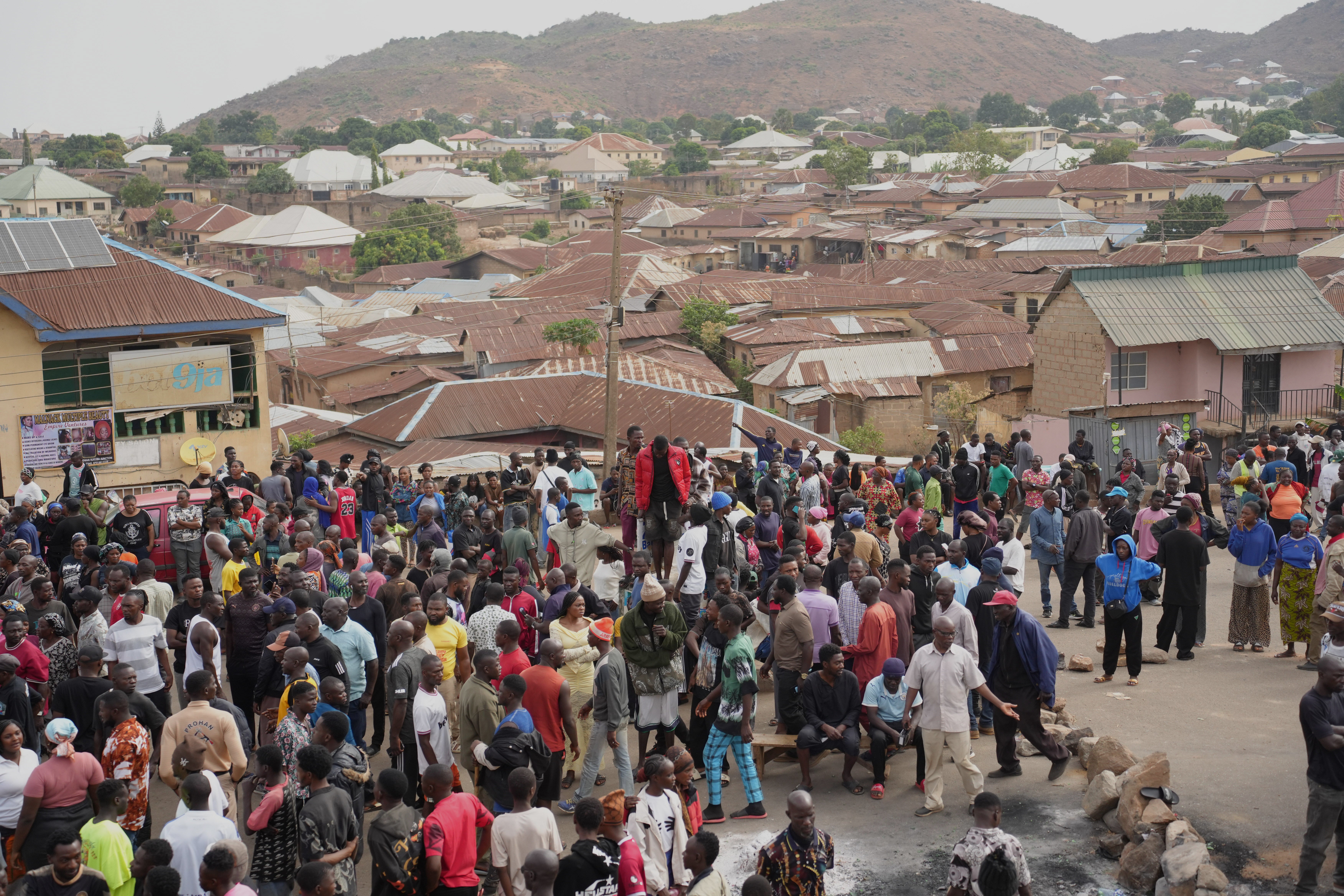 People gather at the scene of Sunday night gunmen attack in Gari Ya Waye community in the Jos North Nigeria