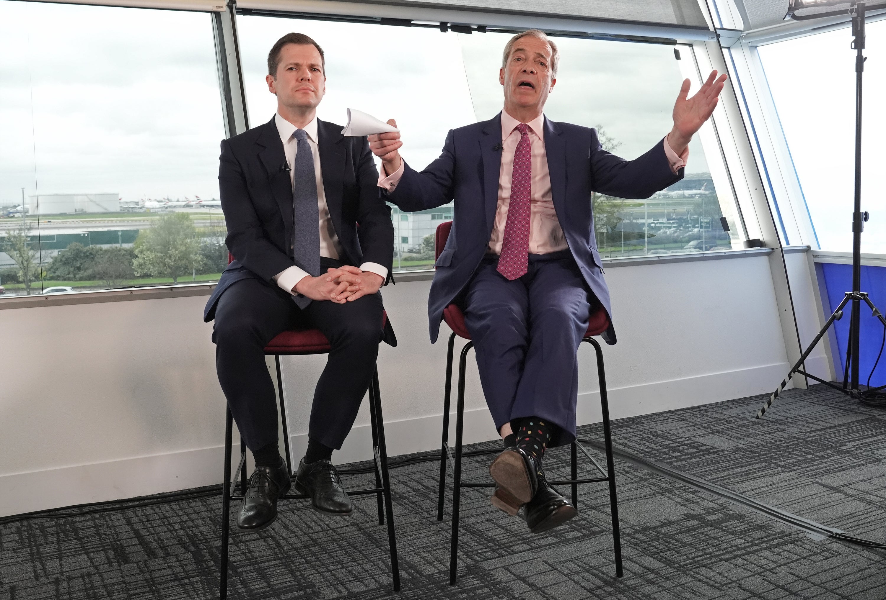 Robert Jenrick and Nigel Farage at Heathrow (Stefan Rousseau/PA)