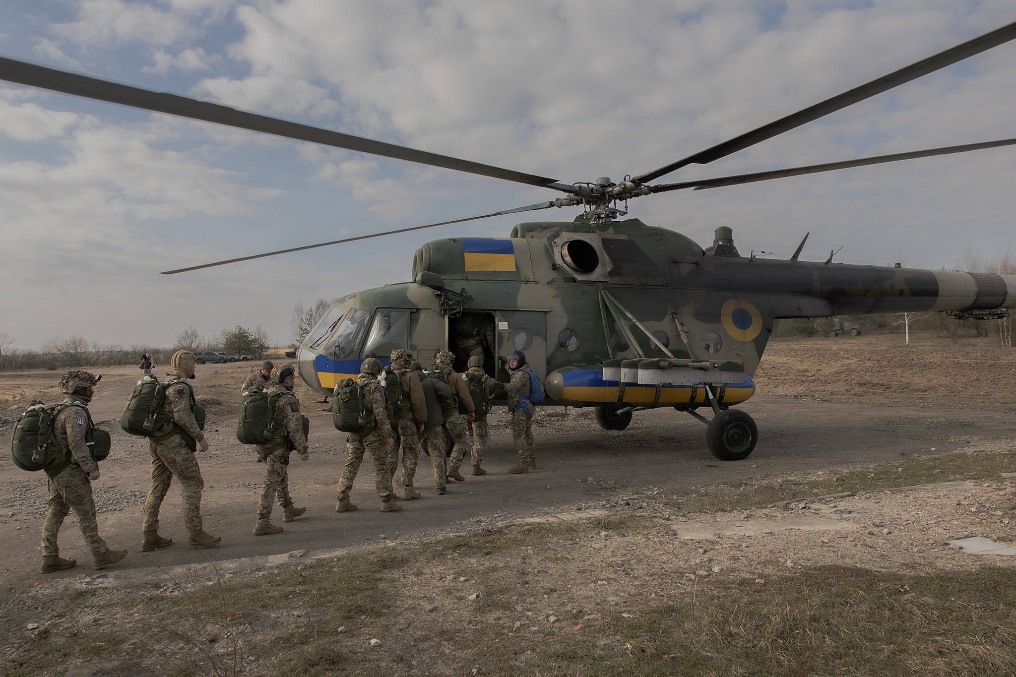 Ukrainian servicemen of Air Assault Forces board a Mi-8 helicopter to conduct parachute jumps training at a training centre in an undisclosed location