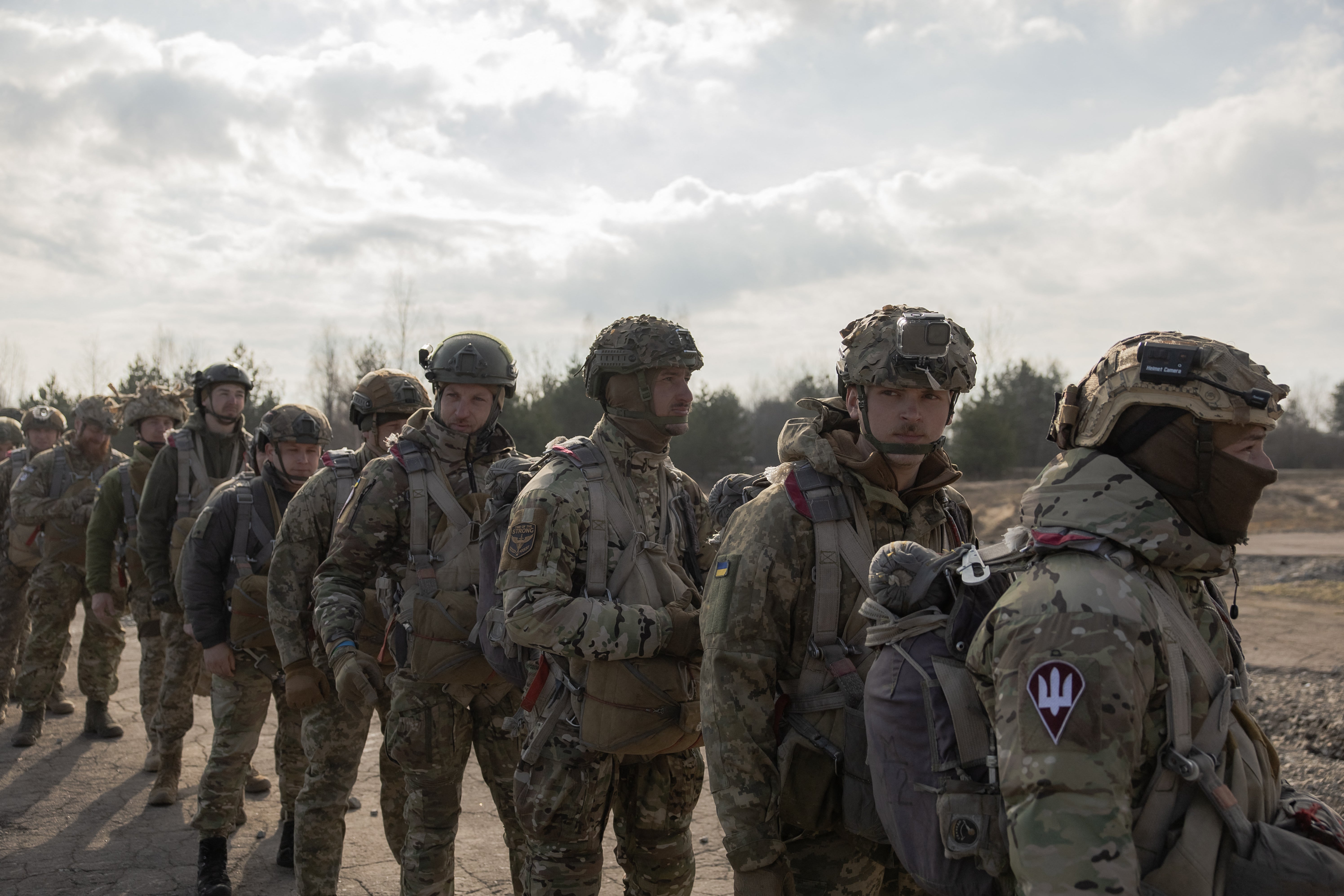 Ukrainian servicemen of Air Assault Forces wait to board a Mi-8 helicopter to conduct parachute jumps training, at a training centre