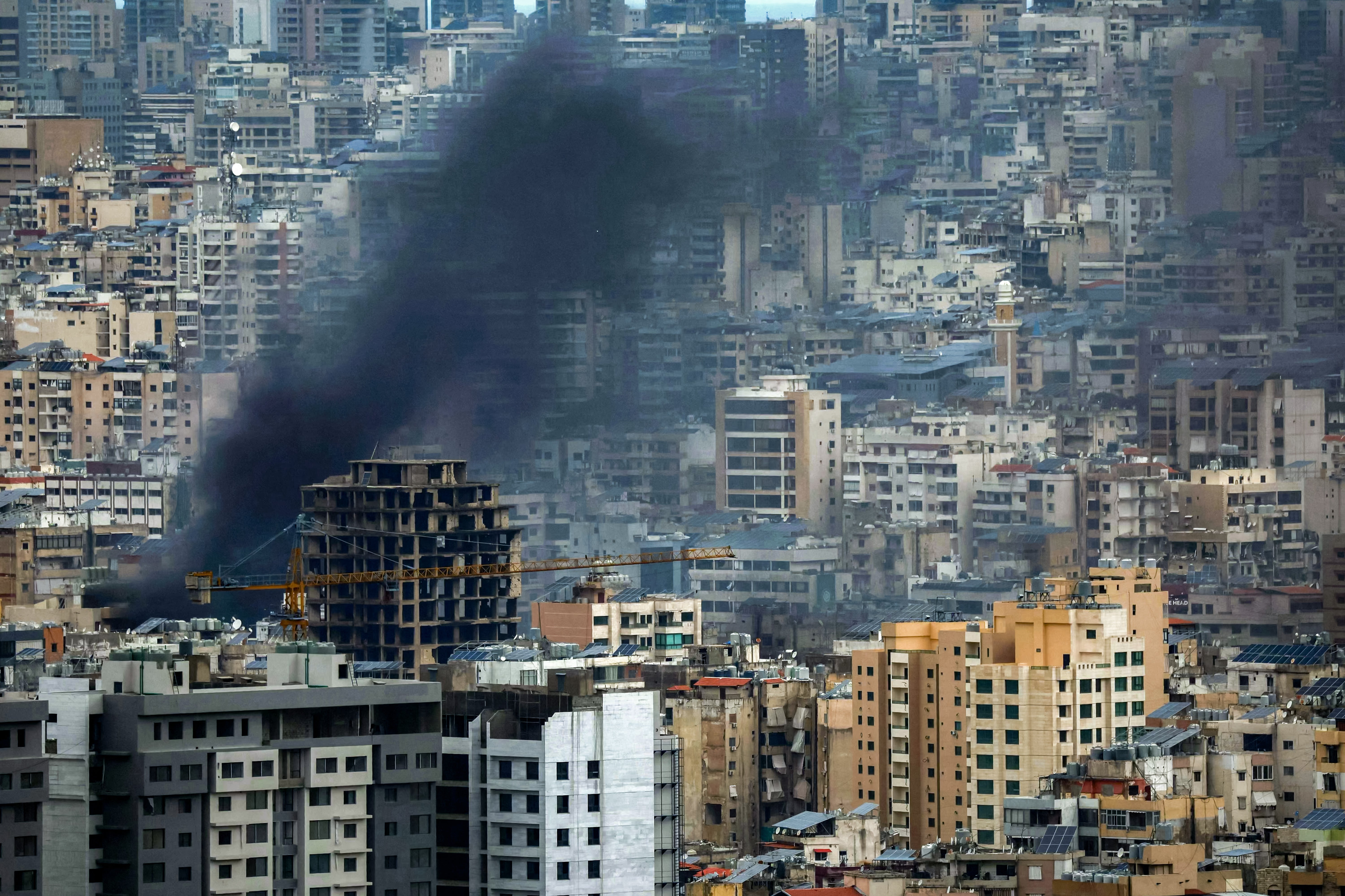 Smoke rises from the site of an Israeli airstrike on Beirut's southern suburbs on 30 March
