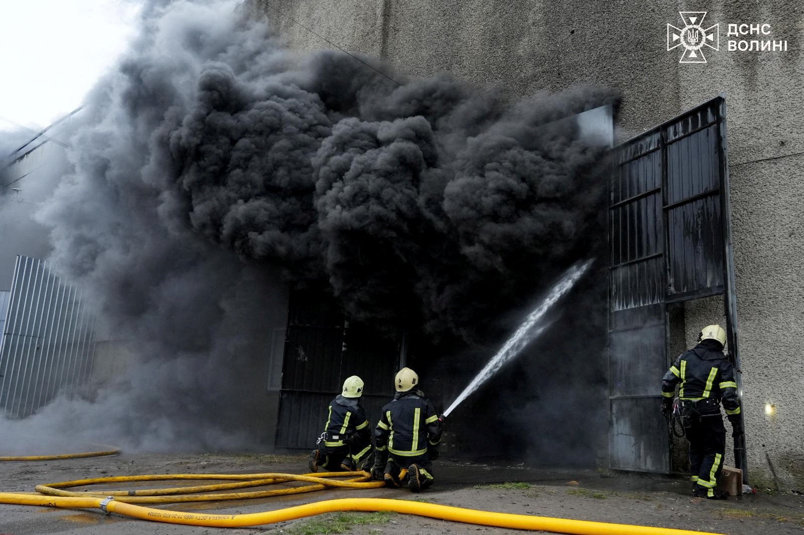 Firefighters work at the site a Russian drone strike in Lutsk, Ukraine