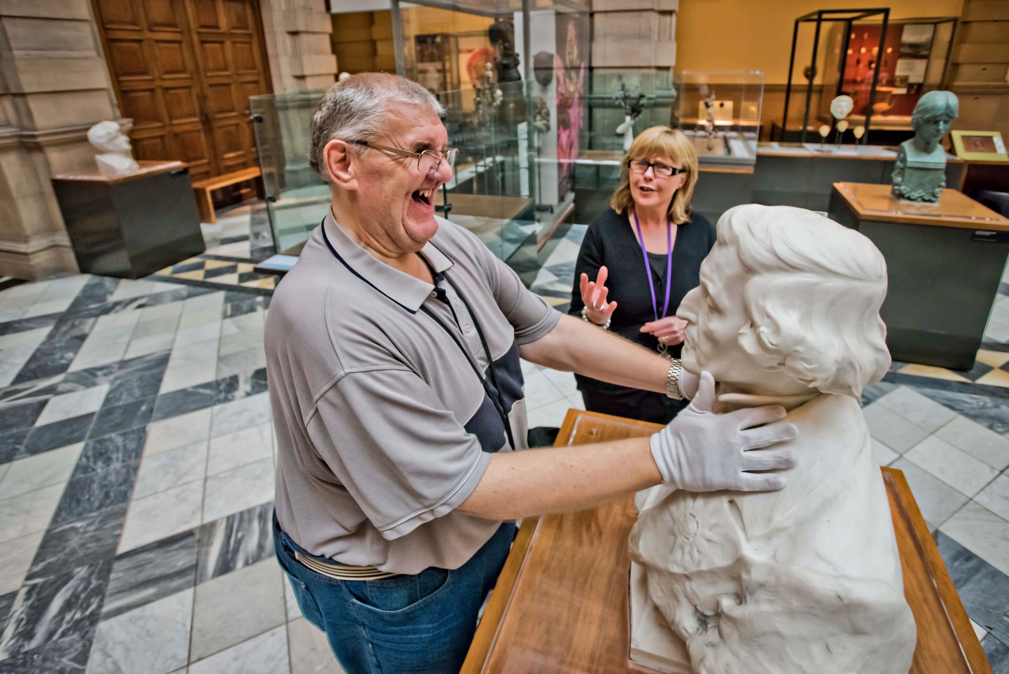 A man is guided around the exhibits on display at The Kelvingrove Art Gallery and Museum