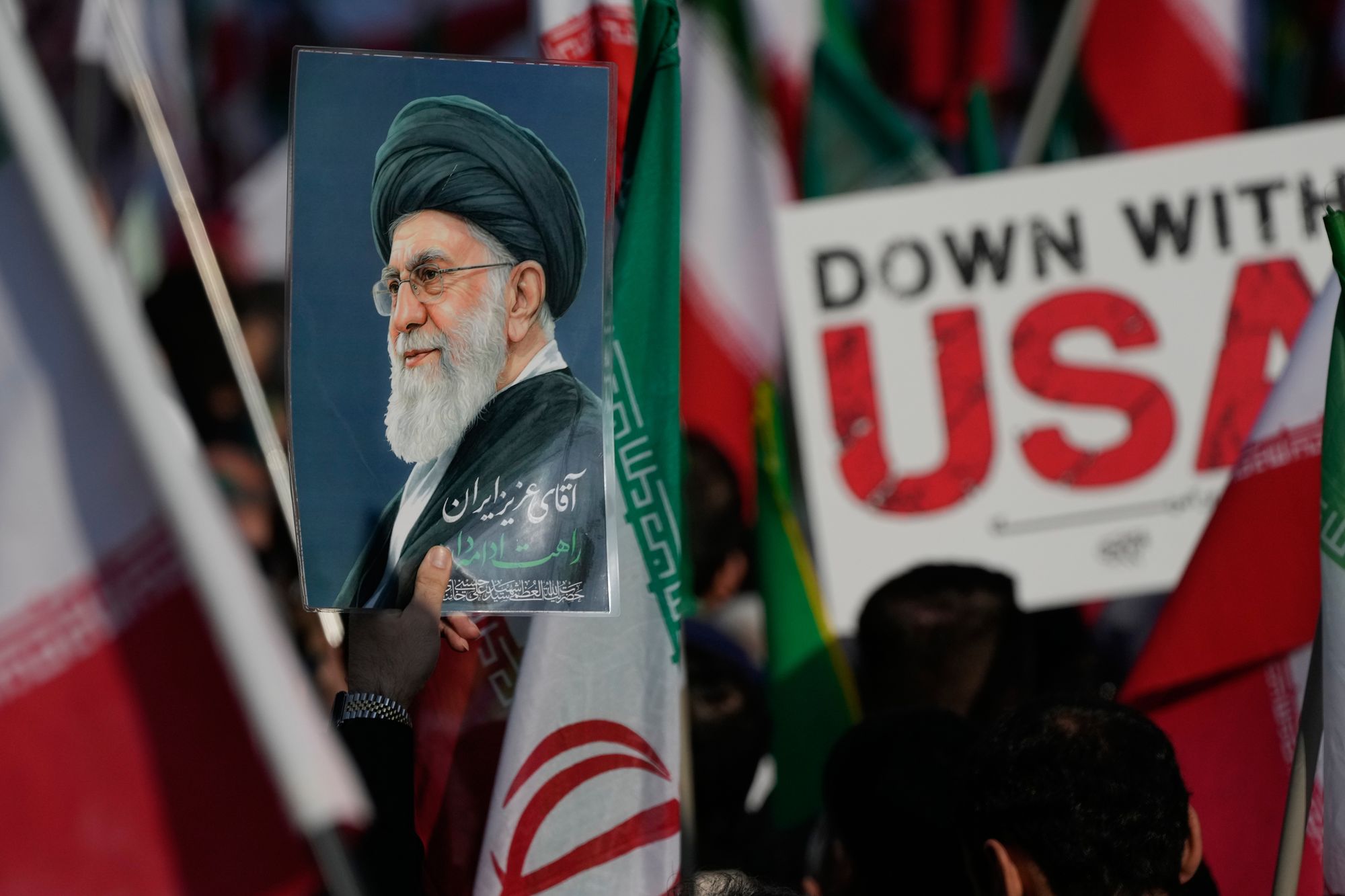 A poster of the late Iranian Supreme Leader Ayatollah Ali Khamenei and an anti-U.S. placard in Tehran