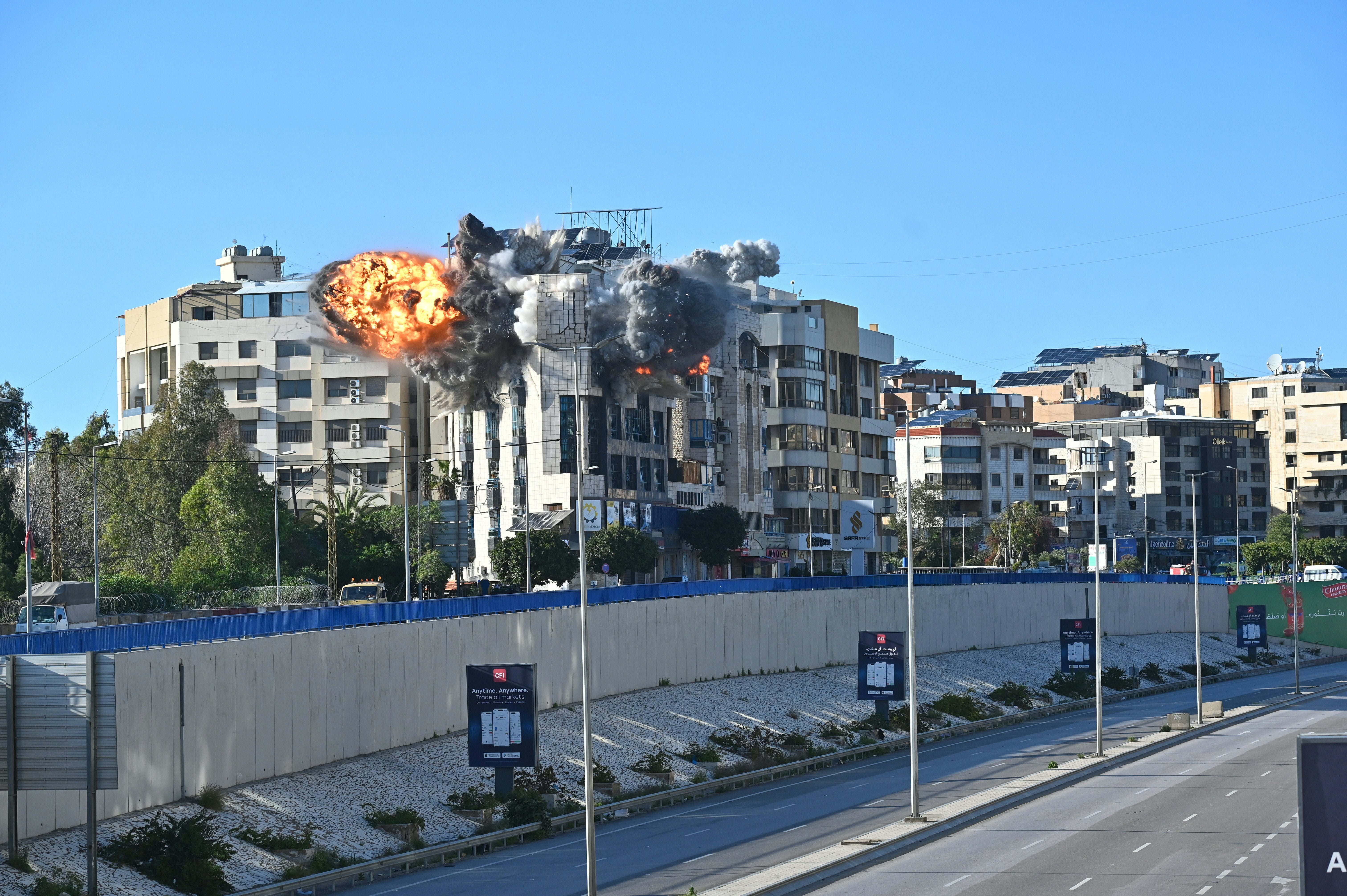 A ball of fire rises from the site of an Israeli strike that targeted a building adjacent to the highway that leads to Beirut's international airport on March 31, 2026