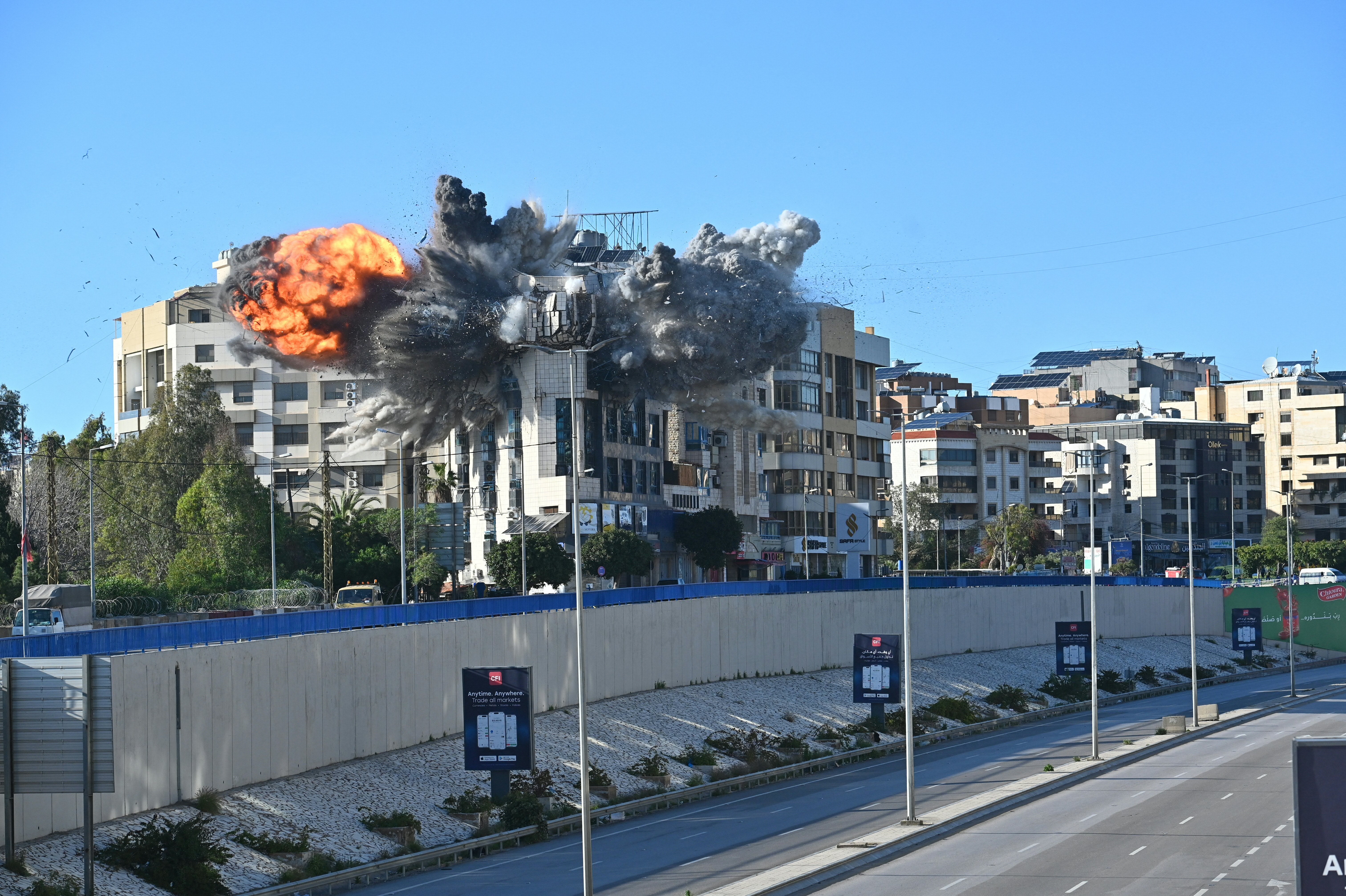 A ball of fire rises from the site of an Israeli strike that targeted a building adjacent to the highway that leads to Beirut's international airport on March 31, 2026