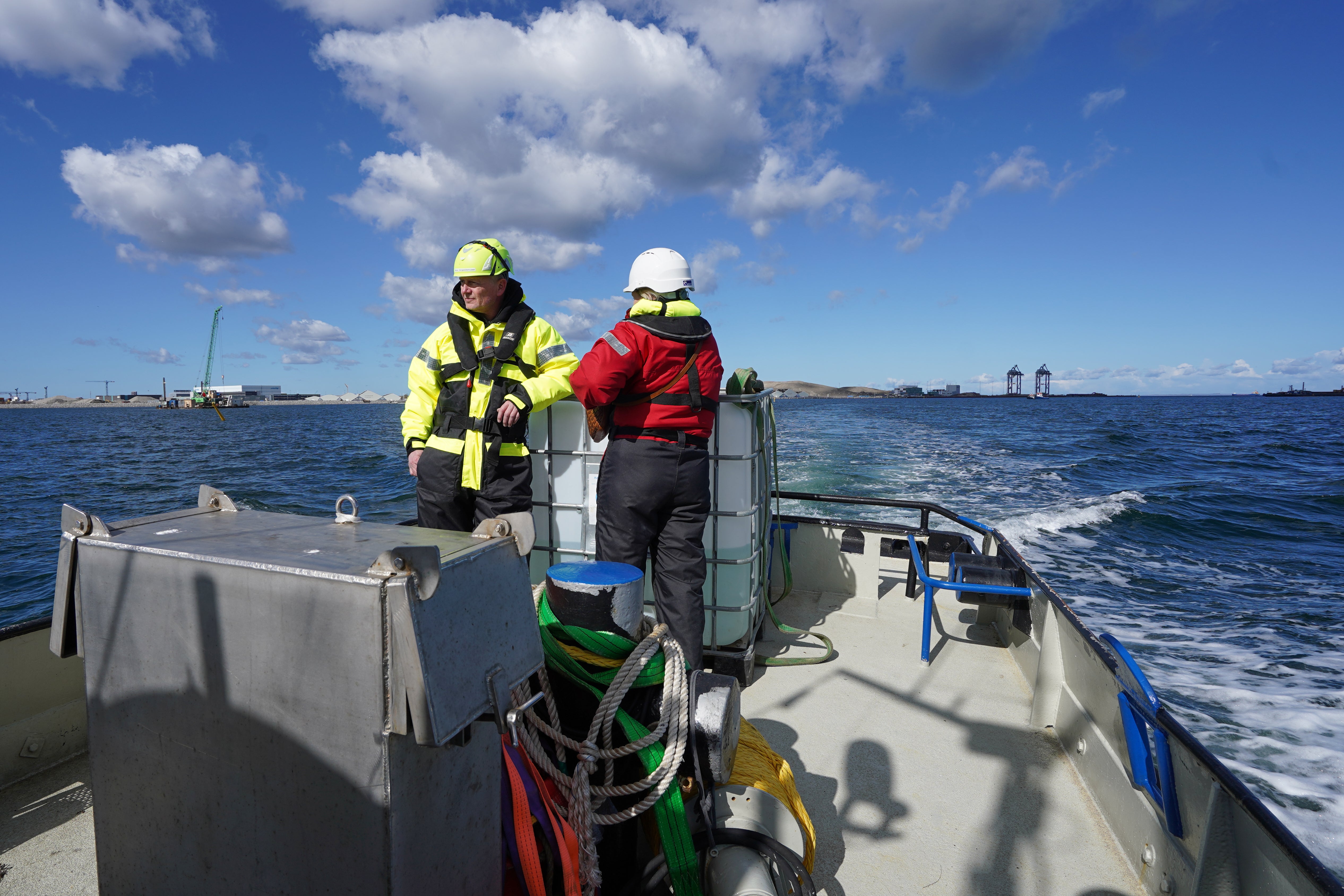 Archaeologists sail with boat through the harbor in Copenhagen