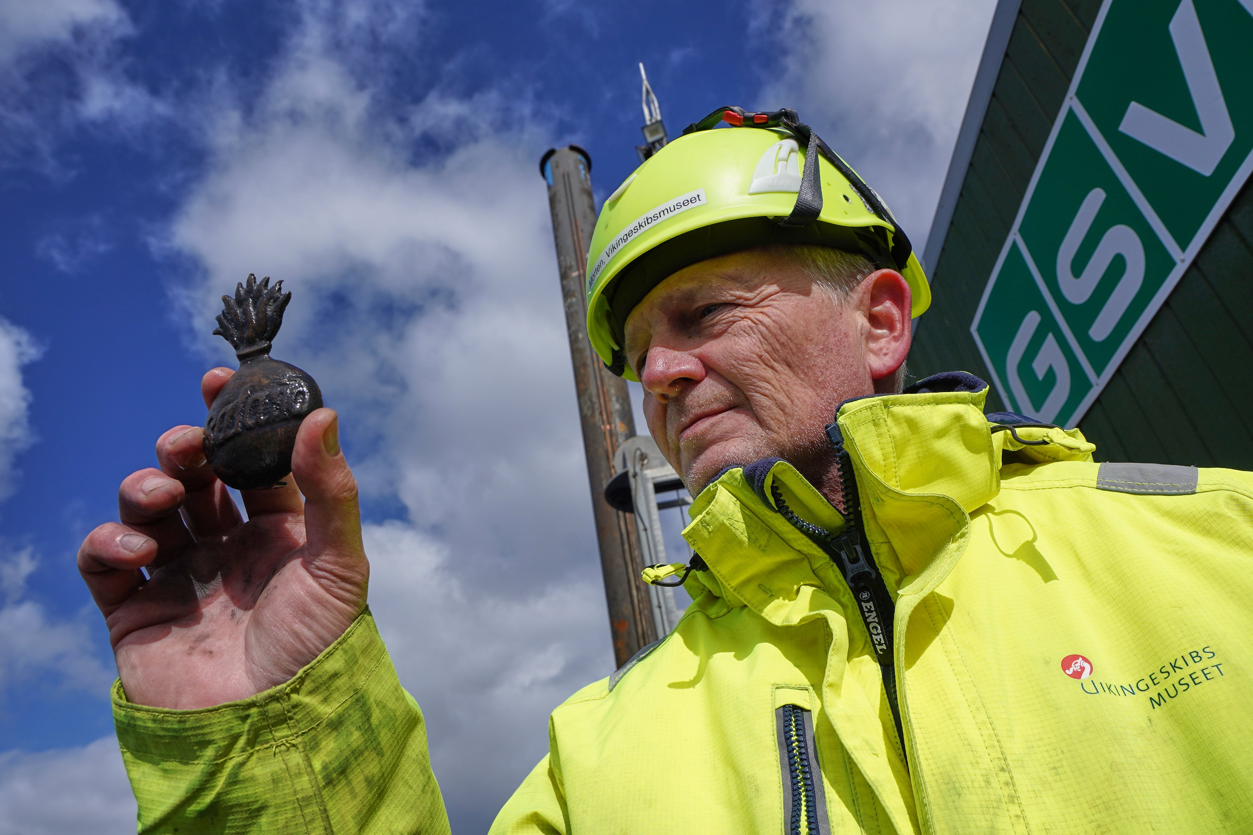Morten Johansen, head of maritime archaeology at Denmark's Viking Ship Museum, shows a metal insignia recovered from the wreck of Danish flagship ‘Dannebroge’ that sank during the Battle of Copenhagen in 1801,