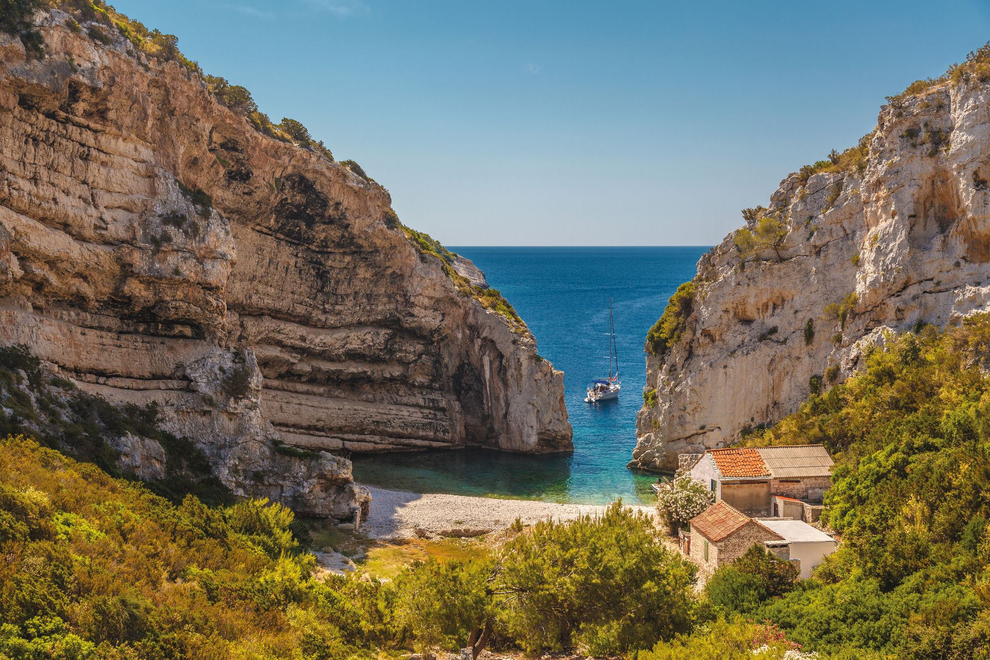 Stiniva Bay boasts dramatic cliffs flanking its pretty beach
