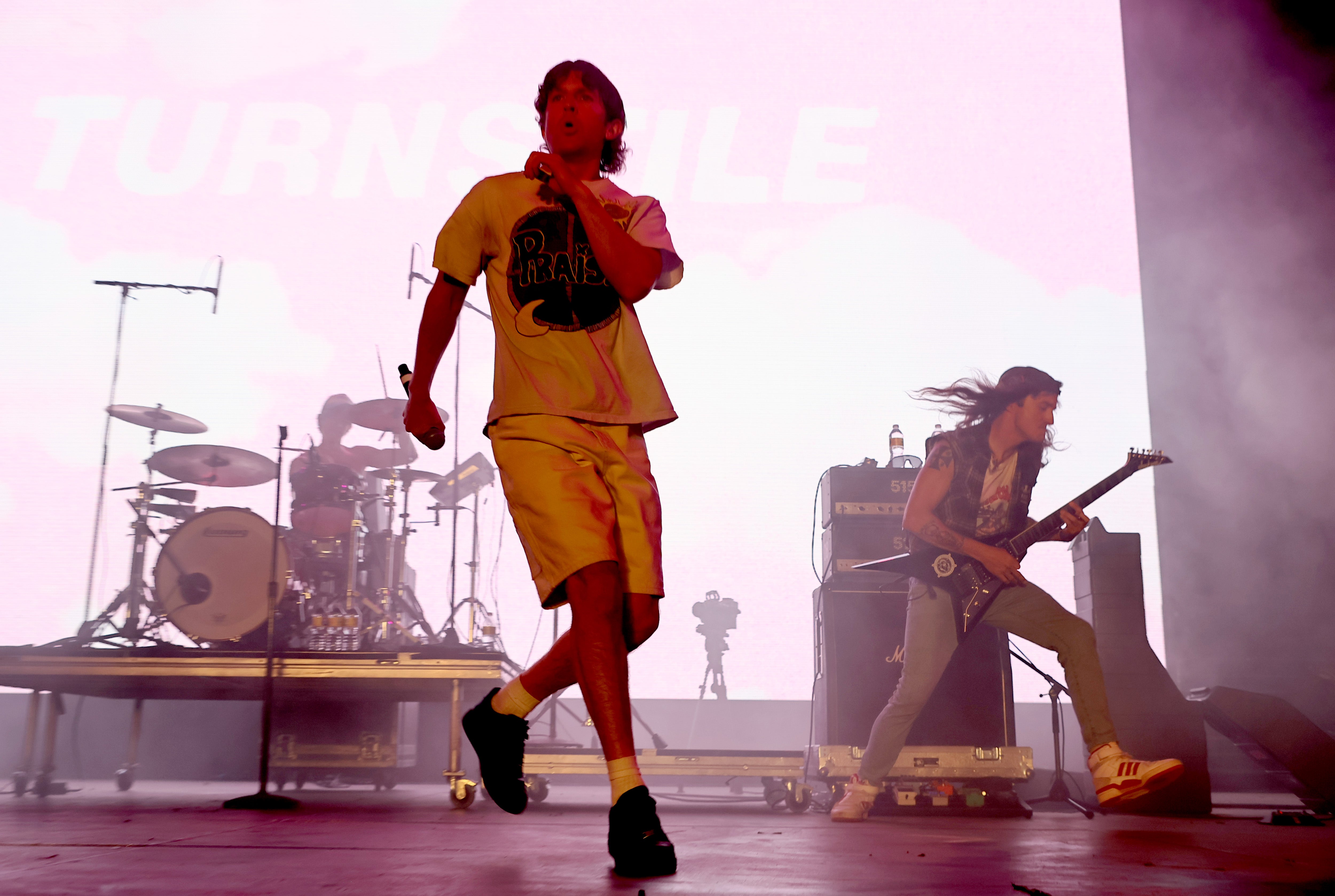 Brady Ebert, pictured playing guitar on stage with singer Brendan Yates, left Turnstile in 2022