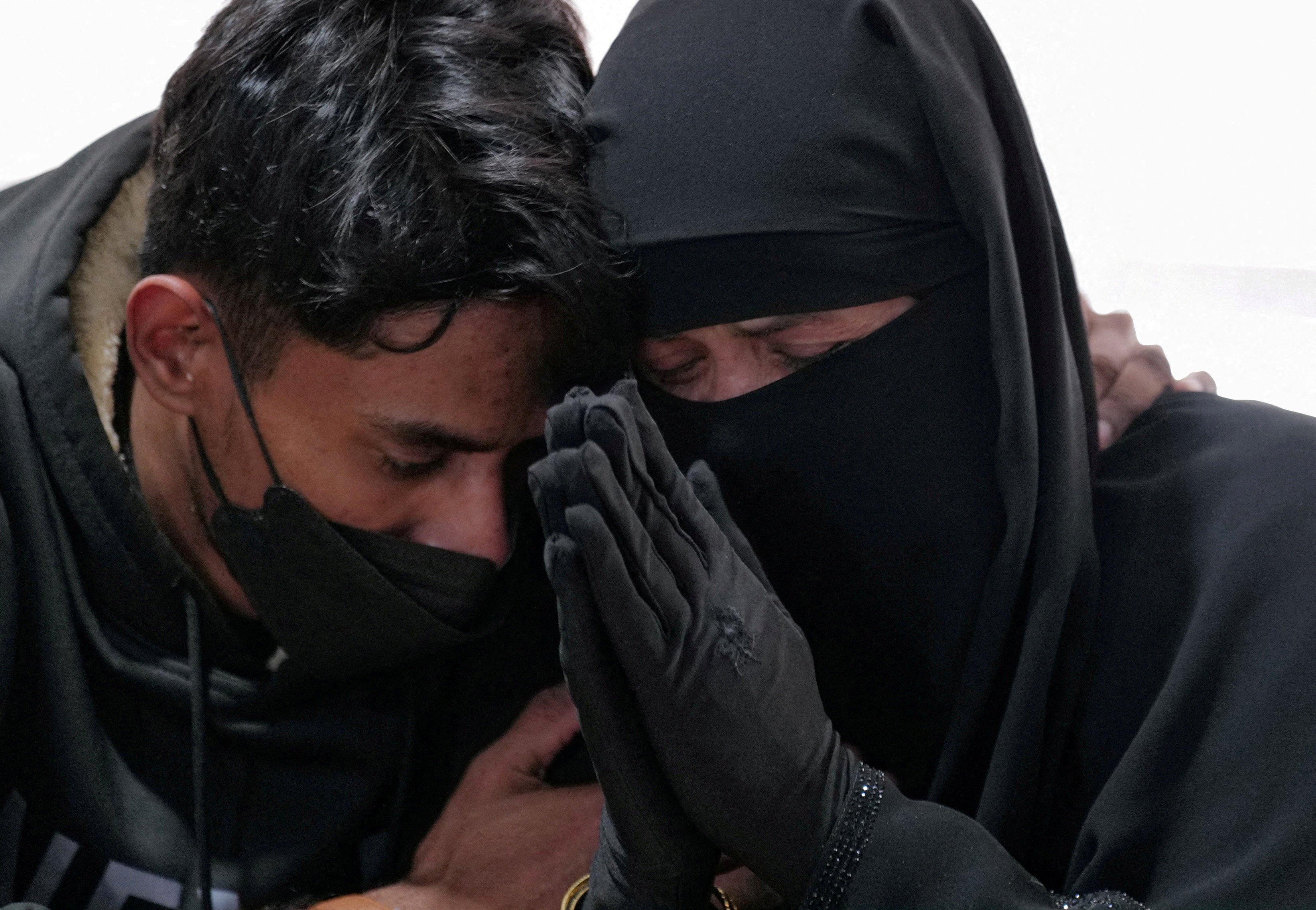 Mohamad Faisal embraces his mother, Fatimah Abdul-Roshid, the wife of Nurul Amin Shah Alam, as the family speaks to reporters in the wake of Shah Alam’s death