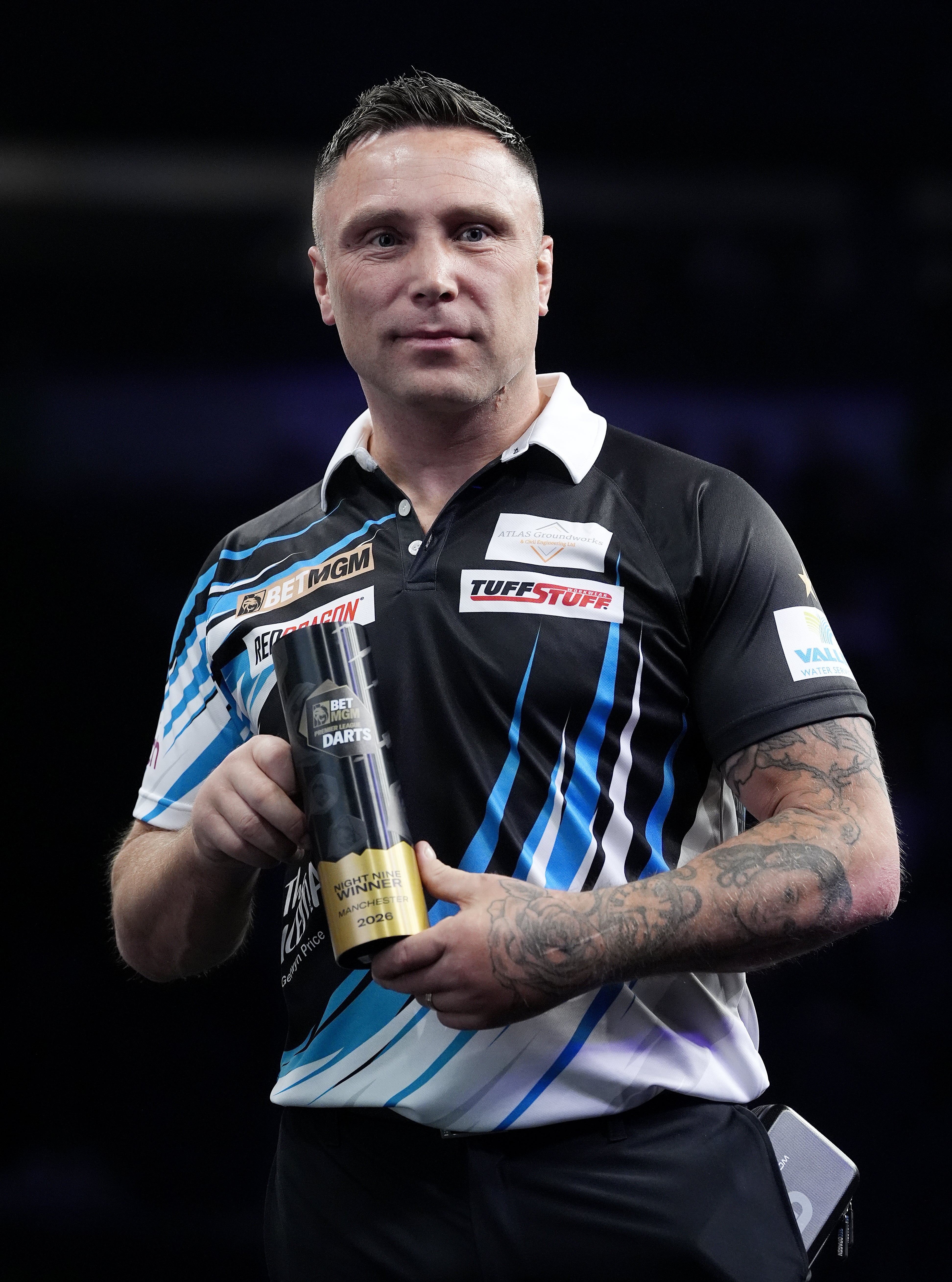 Gerwyn Price poses with the trophy (Peter Byrne/PA)
