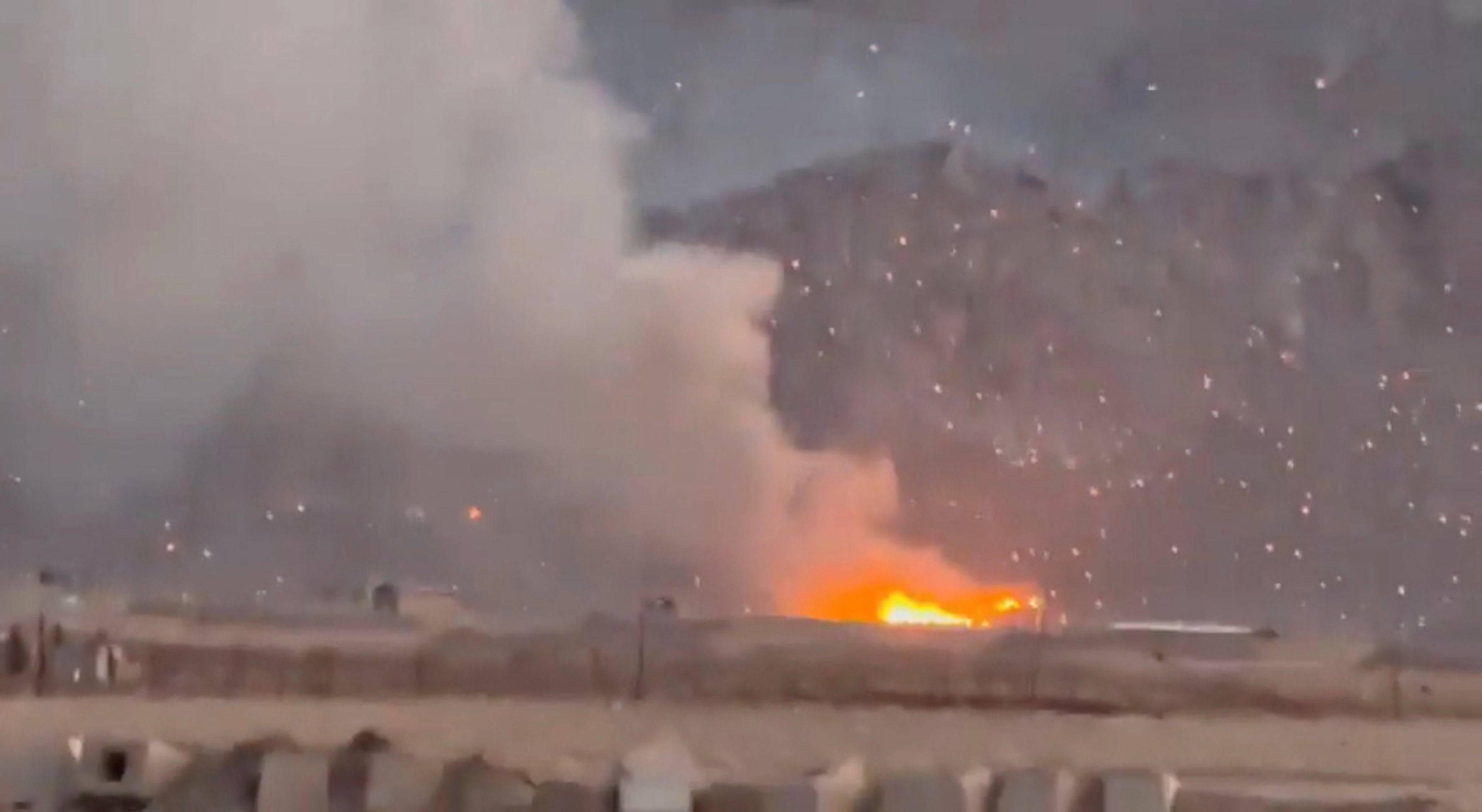 Smoke rises following a reported strike, as burning debris litter the surrounding area, amid the US-Israeli conflict with Iran, in Baharestan, Isfahan province, Iran, in this screengrab taken from a social media video released on 1 April 2026