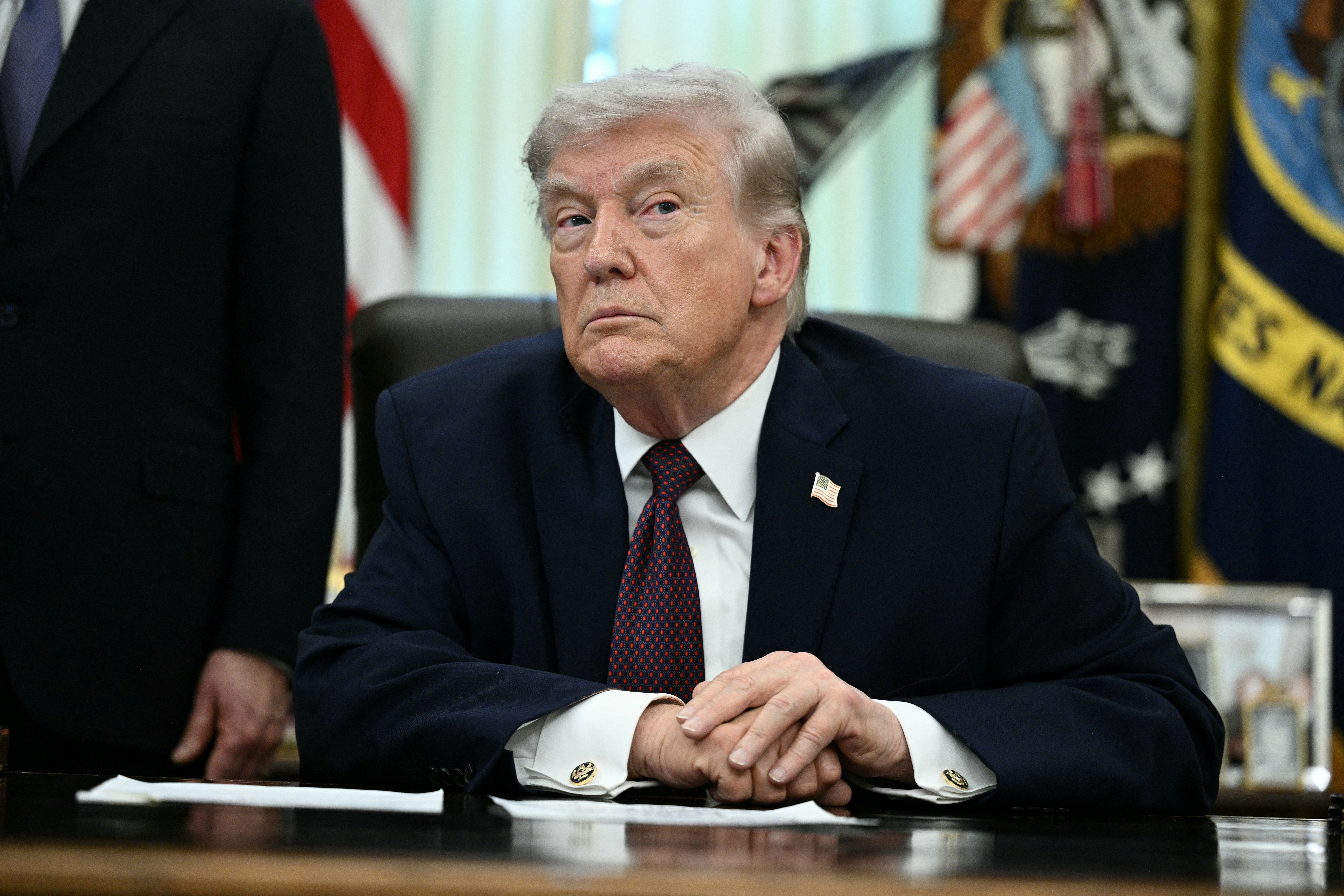 US President Donald Trump takes a question from a reporter after signing an executive order in the Oval Office of the White House in Washington, DC, on March 31, 2026. (Photo by Brendan SMIALOWSKI / AFP via Getty Images)