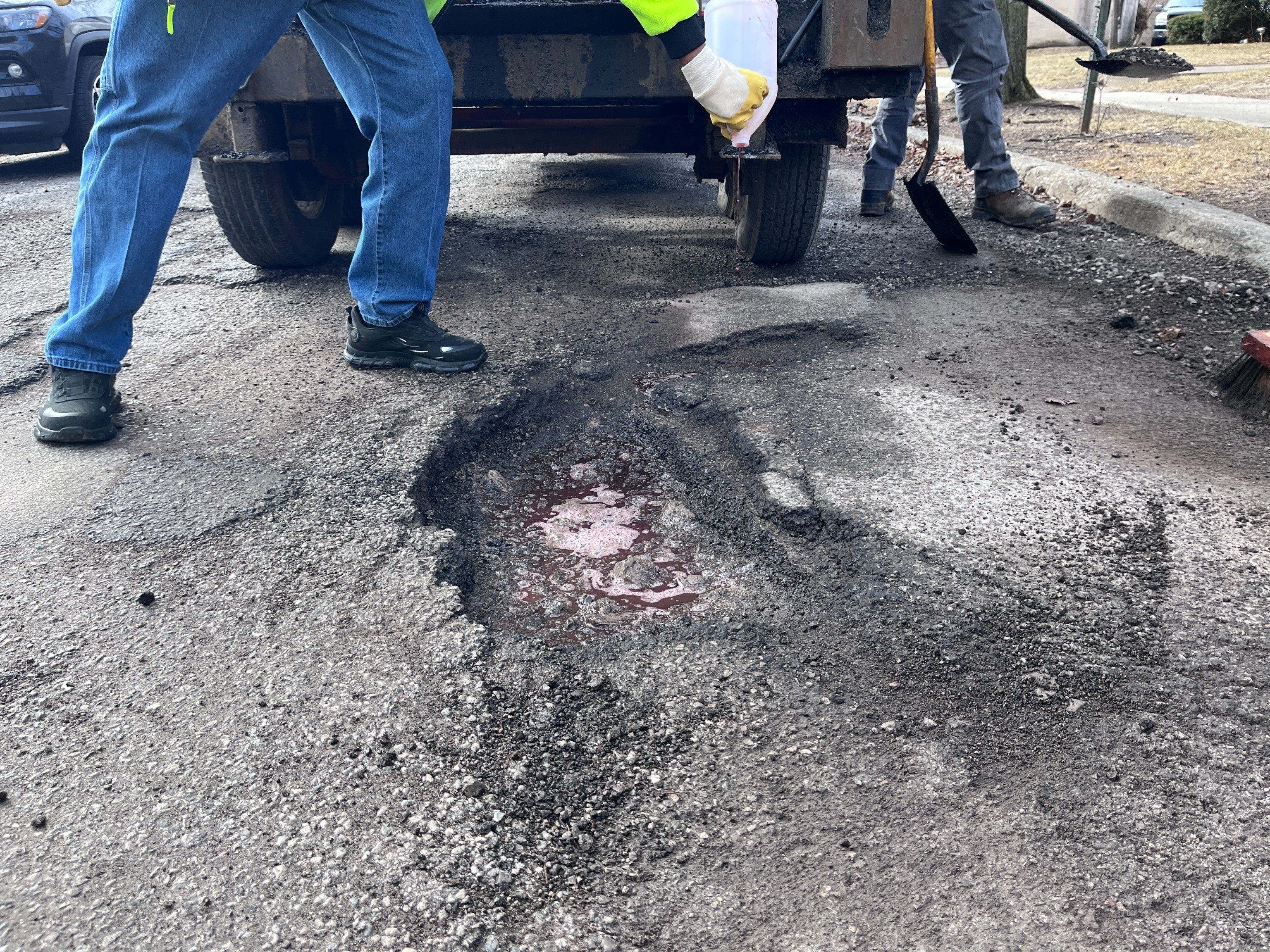 Workers with the Department of Transportation of Toledo, Ohio, fill in a pothole in early March. The East Coast and Midwest were battered by heavy snow and sub-zero temperatures for weeks in early 2026, leaving behind tens of thousands of potholes on roads and highways
