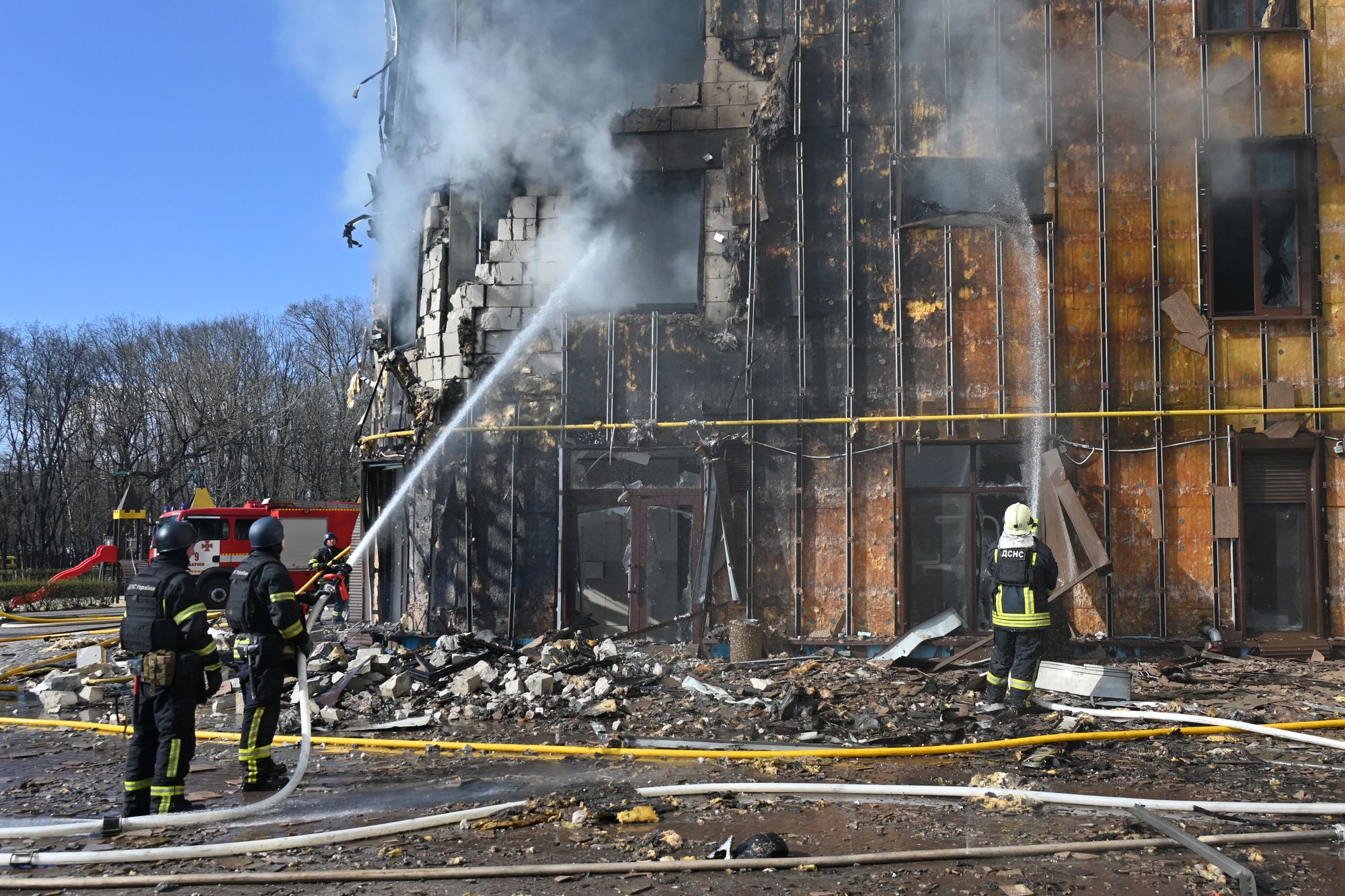 Ukrainian rescuers work to extinguish a fire in a damaged residential building following a drone attack in Kharkiv on 2 April 2026