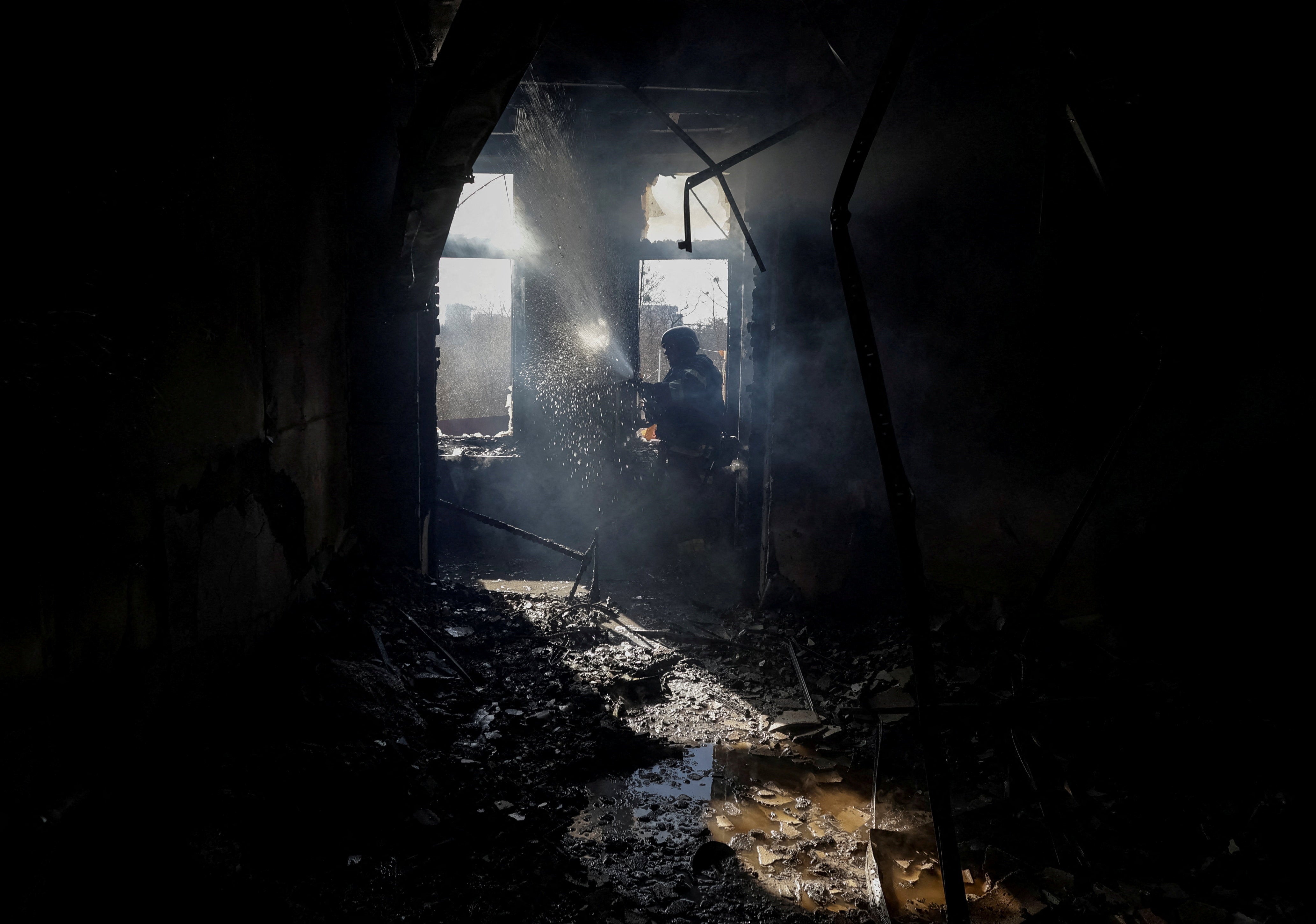 A firefighter works at an apartment building hit by a Russian drone strike, amid Russia's attack on Ukraine, in Kharkiv, Ukraine, 2 April 2026