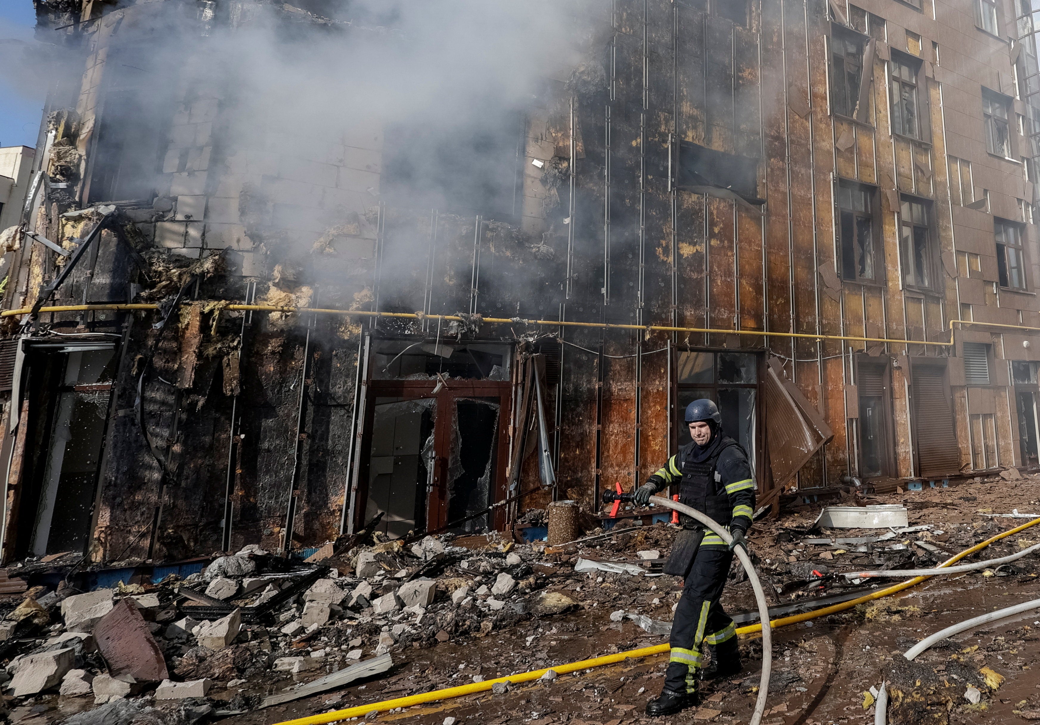 A firefighter works at the scene outside an apartment building hit by a Russian drone strike, amid Russia's attack on Ukraine, in Kharkiv, Ukraine, 2 April 2026