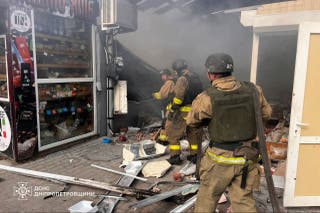 Firefighters put out a fire at the market following a strike in Nikopol