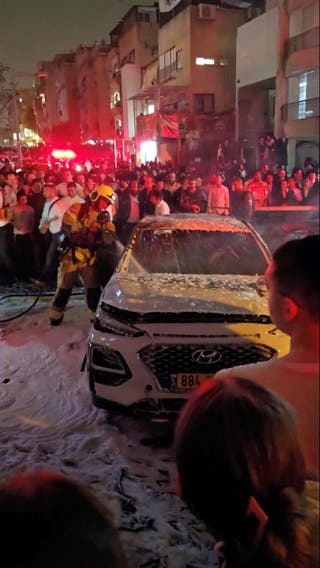 A firefighter works at the scene of a missile strike amid the U.S-Israeli conflict with Iran, in Bnei Brak, Israel