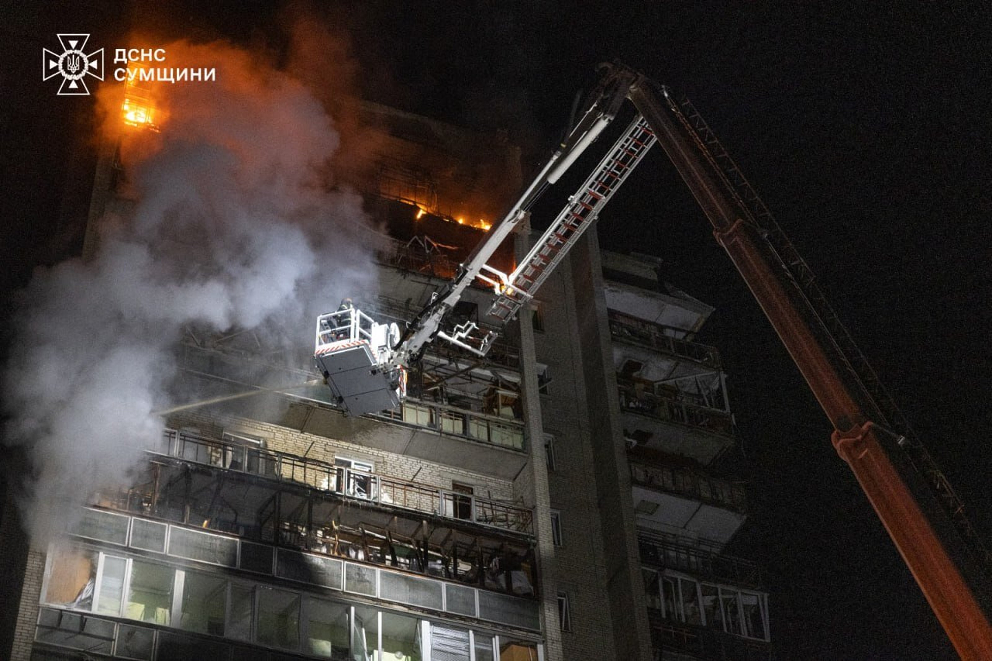 Rescue workers put out a fire of a residential building damaged following a Russian strike in Sumy, Ukraine