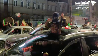 A 'teenager' holds an assault rifle in Mashhad, Iran in footage shared on 30 March