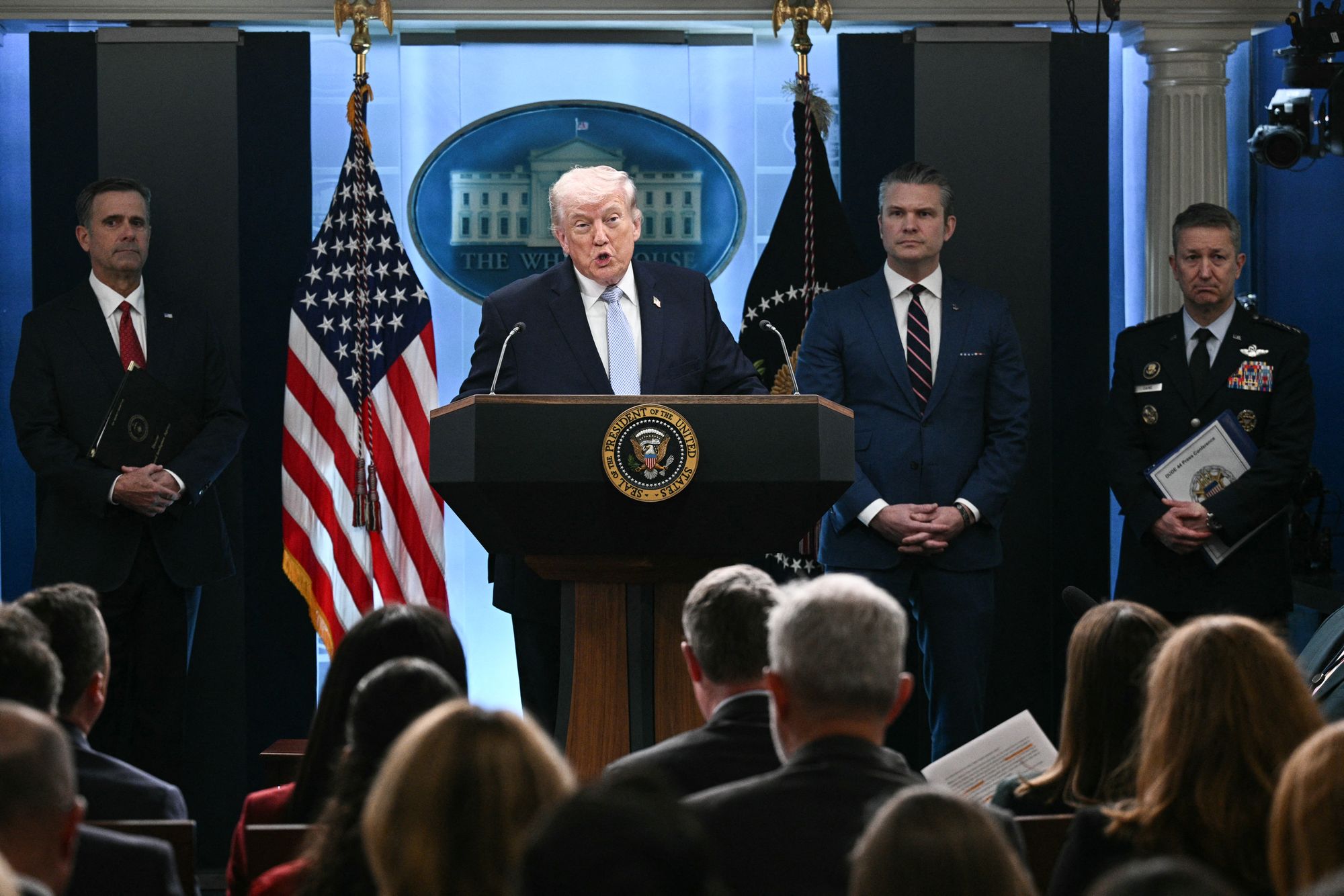 US President Donald Trump, alongside CIA Director John Ratcliffe (L), US Secretary of Defense Pete Hegseth (2R) and Chairman of the Joint Chiefs of Staff General Dan Caine (R), speaks about the conflict in Iran in the James S. Brady Press Briefing Room of the White House on April 6, 2026, in Washington, DC