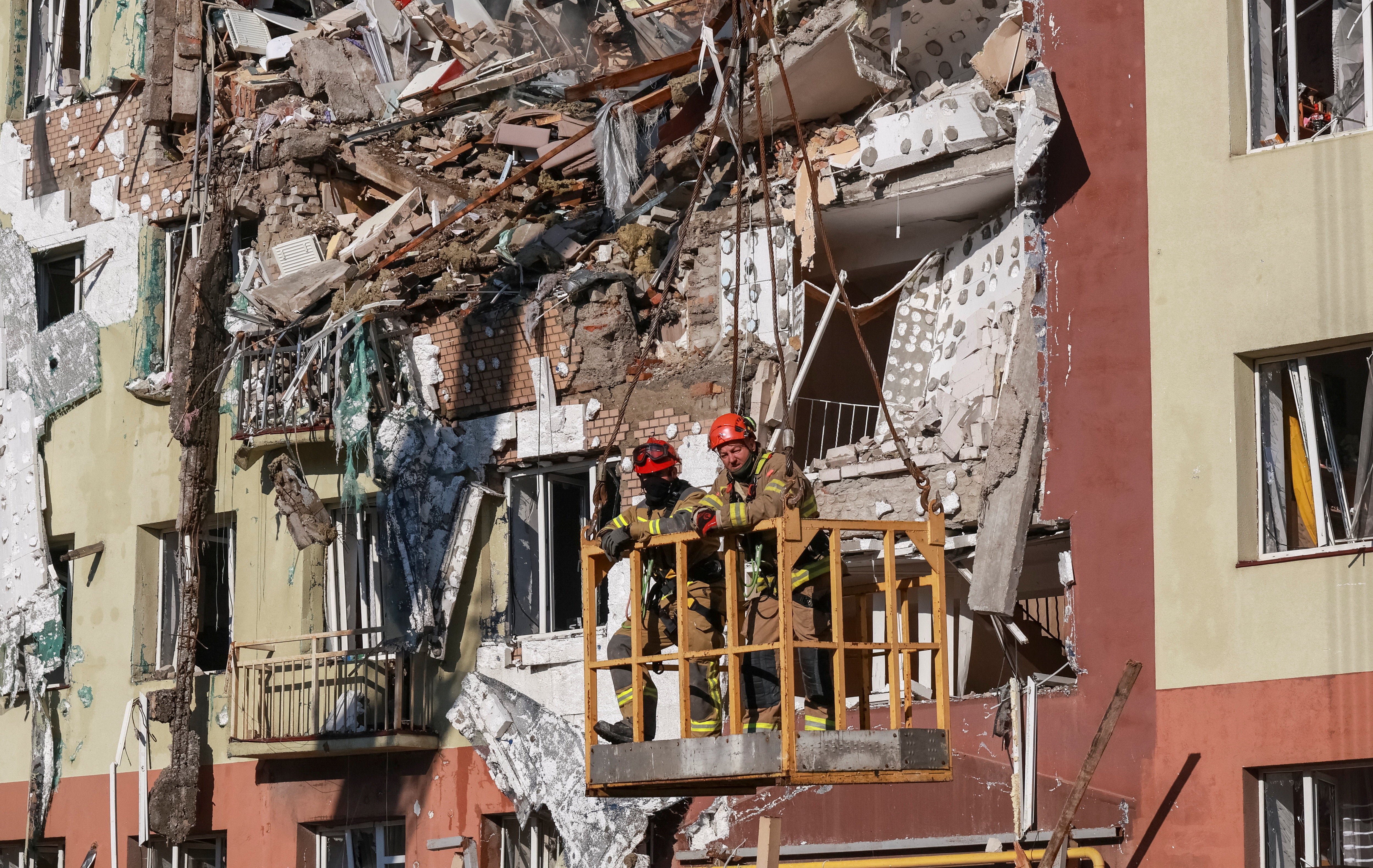 Rescuers work at a site an apartment building hit by a Russian drone strike in Odesa