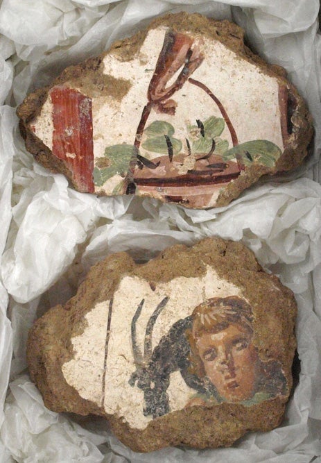 Two of over 5,000 fragments of painted wall plaster from the cult district