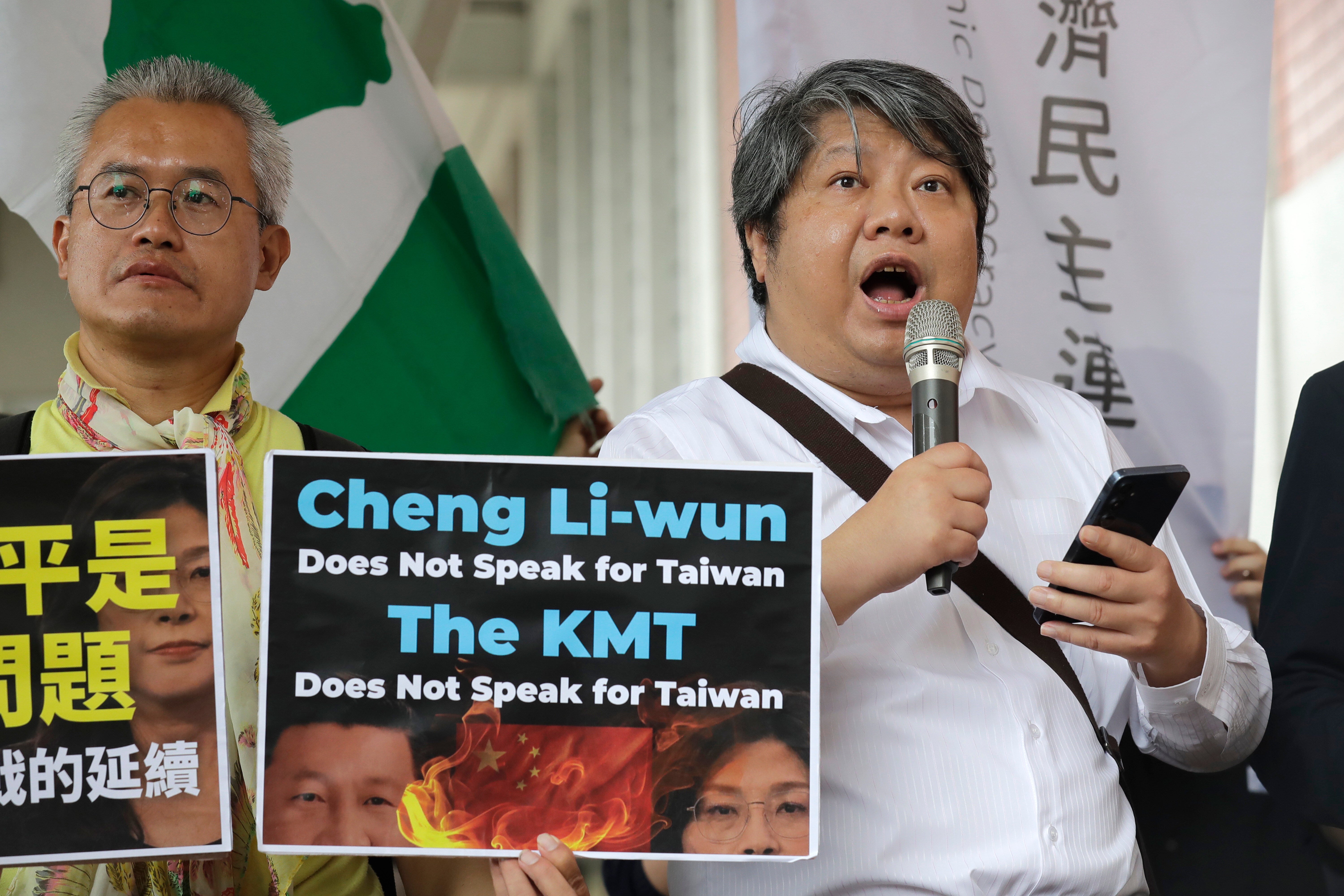 A protester delivers a speech as Taiwan's main opposition Nationalist Party, or Kuomintang (KMT) chairperson Cheng Li-wun leaves for China