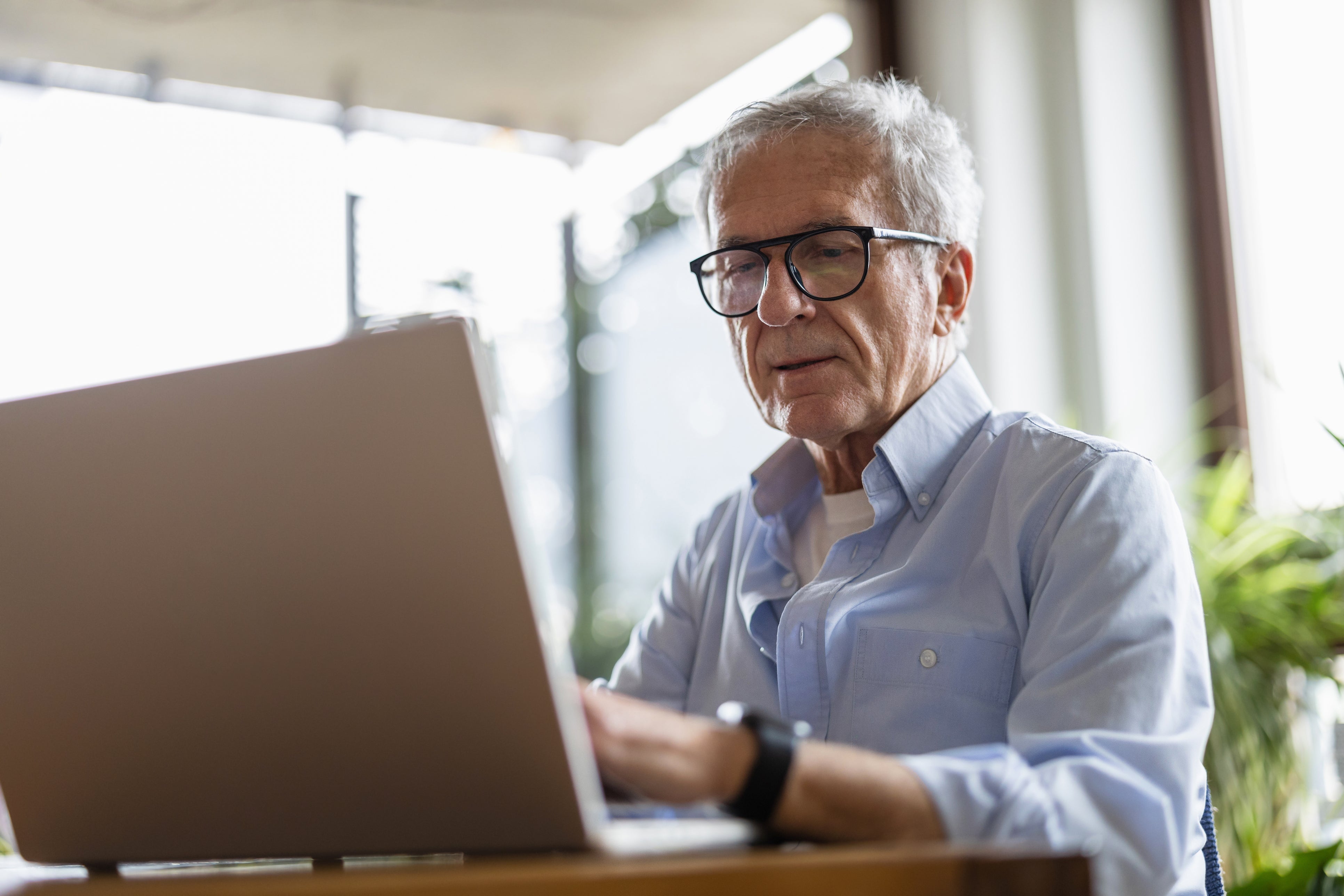 Some older professionals are opting to retire early instead of learning how to implement AI into their jobs, according to a report (file image)