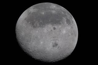 Moon's near side identifiable by the dark splotches represent ancient lava flows from an early time when it was volcanically active.