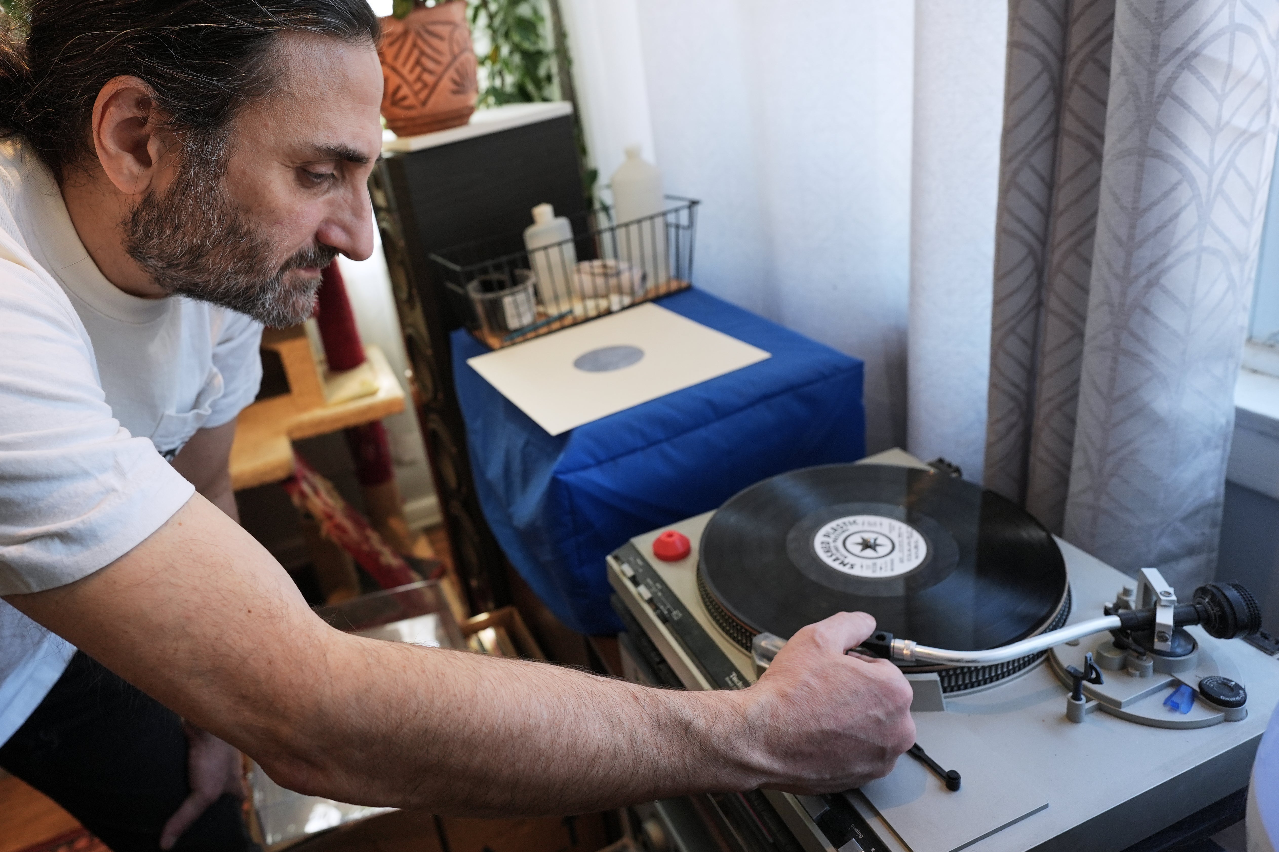 Aadam Jacobs plays an LP at his home in Chicago