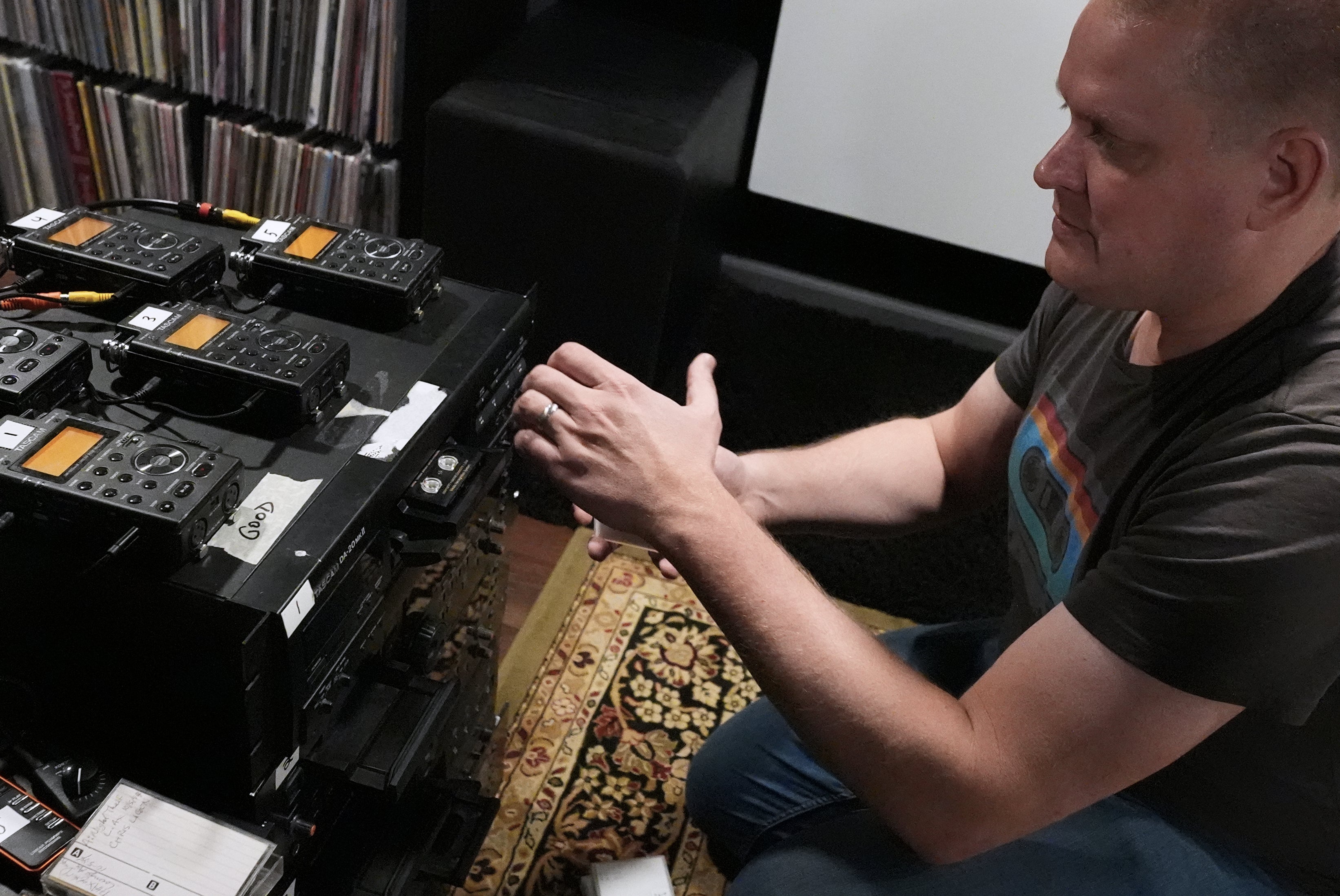 Brian Emerick plays a recorded tape at his home in Des Plaines, Illinois