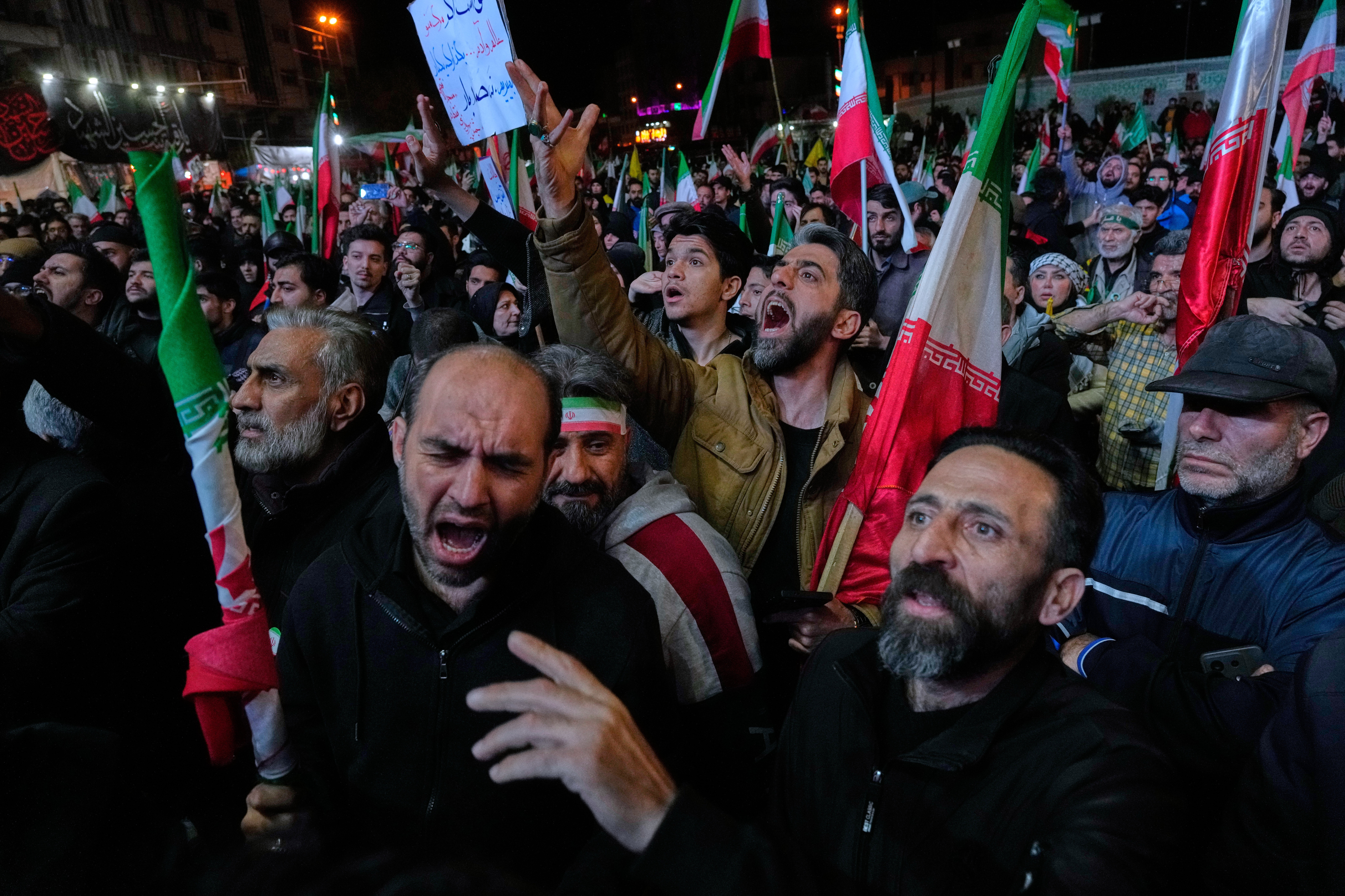 Iranian pro-government demonstrators in Tehran react to the announcement of a two-week ceasefire