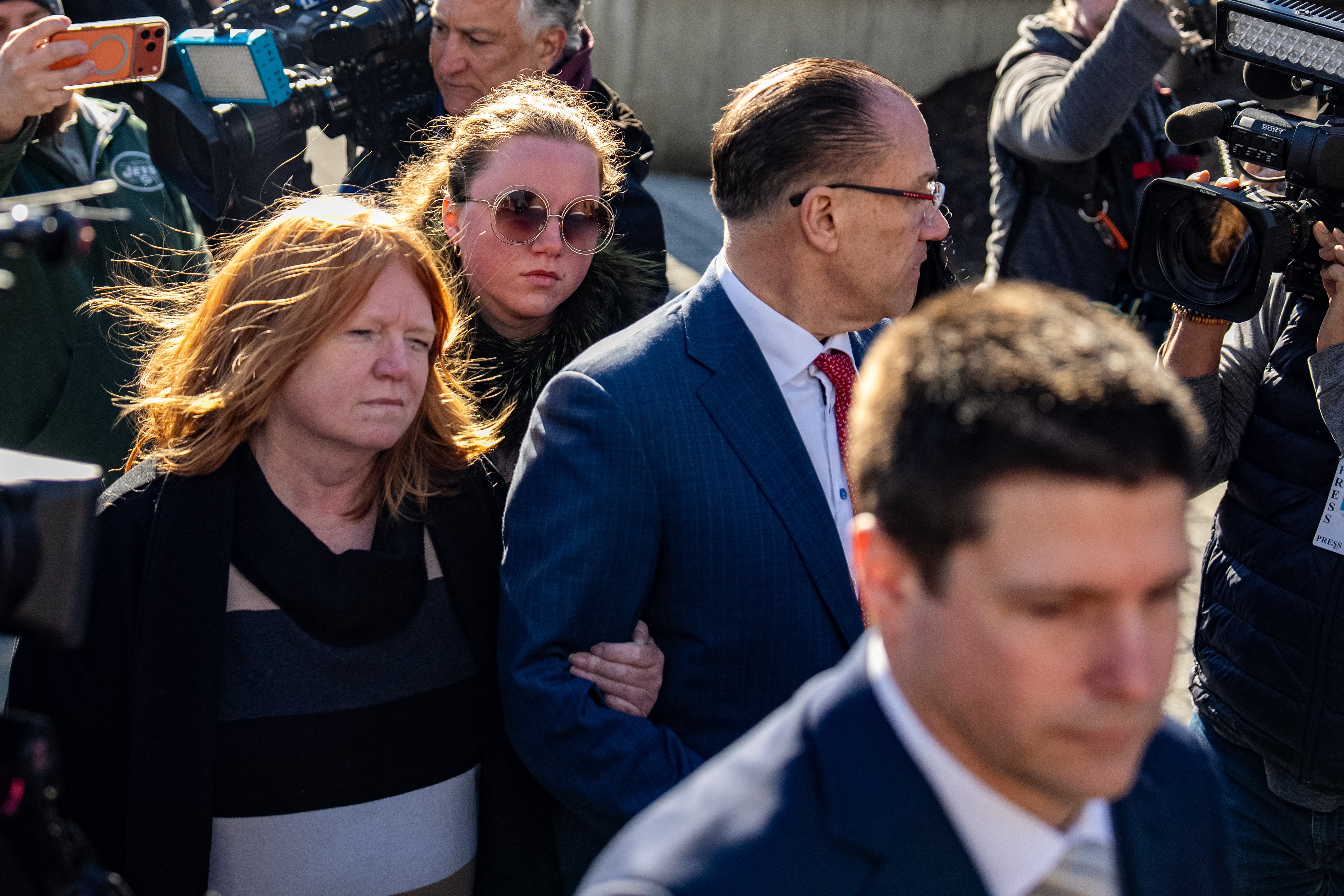 Asa Ellerup (left), the ex-wife of Rex Heuermann, and their daughter Victoria Heuermann (right) were swarmed by reporters as they entered the courthouse