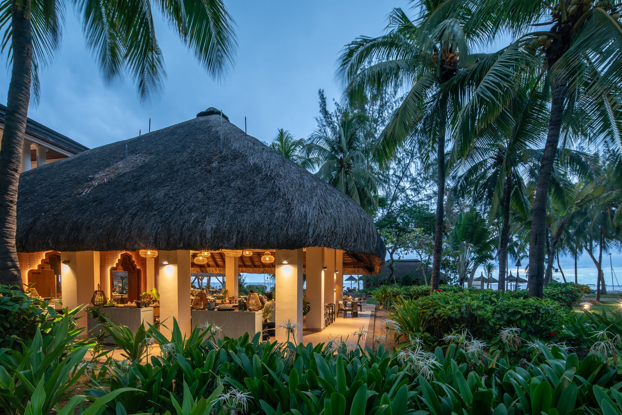 The resort is surrounded by lush tropical gardens and has access to white sands