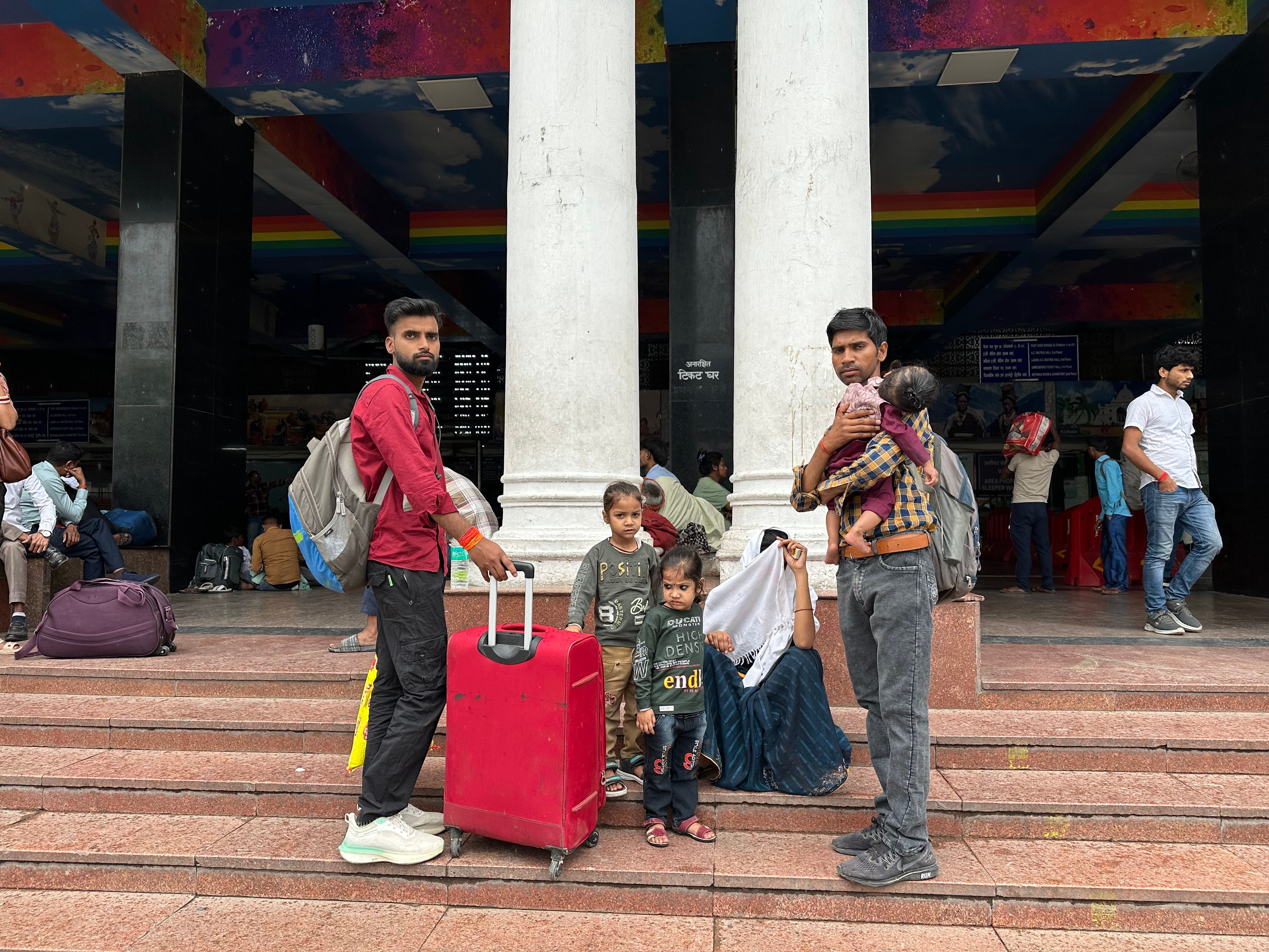 Ram Vilas Yadav waits with his family to board a train to his village in Bihar