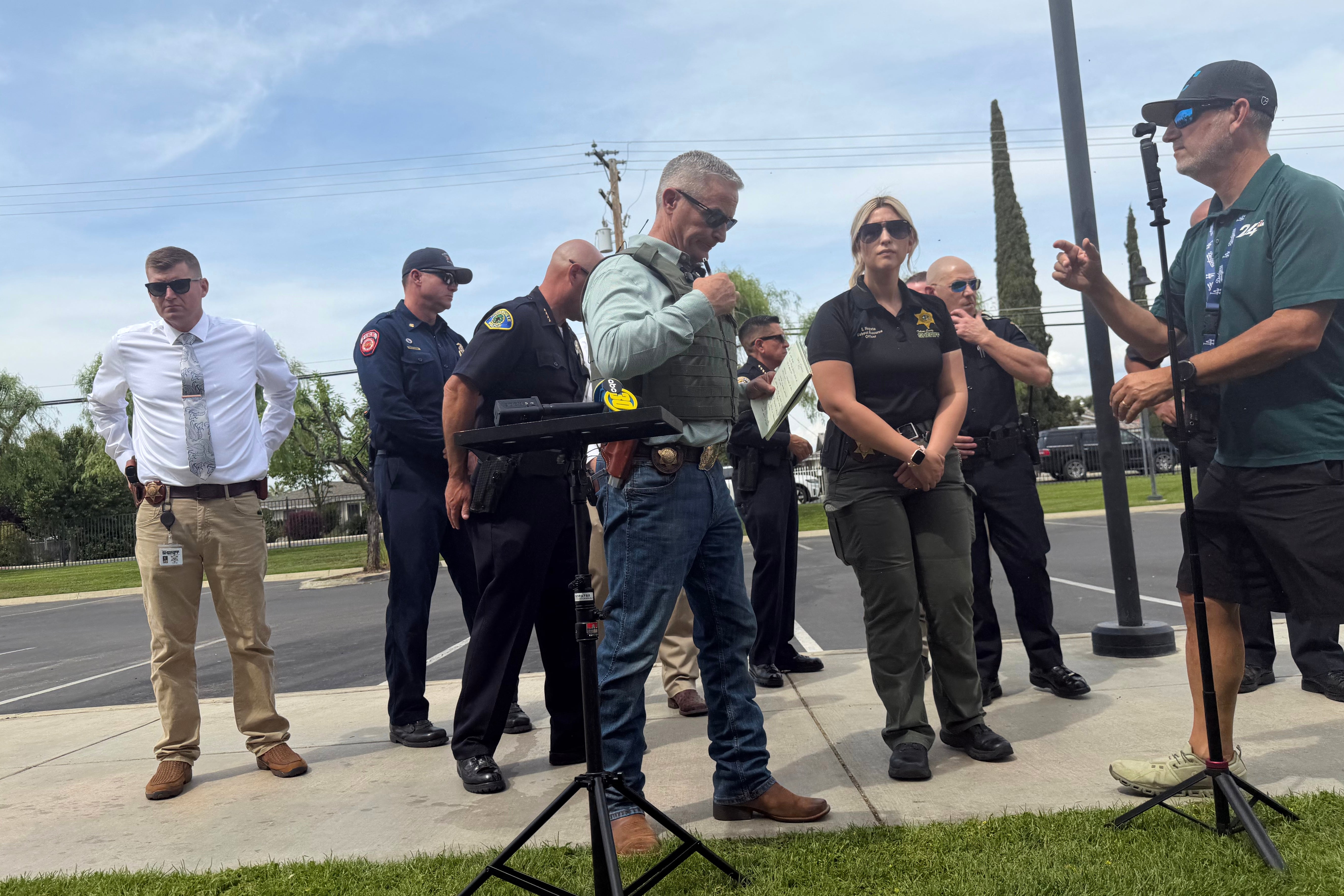 Tulare County Sheriff Mike Boudreaux, center, attends a news conference after a sheriff's deputy was shot and killed Thursday, April 9, 2026, in Porterville, Calif. (Tulare County Sheriff's Office via AP)