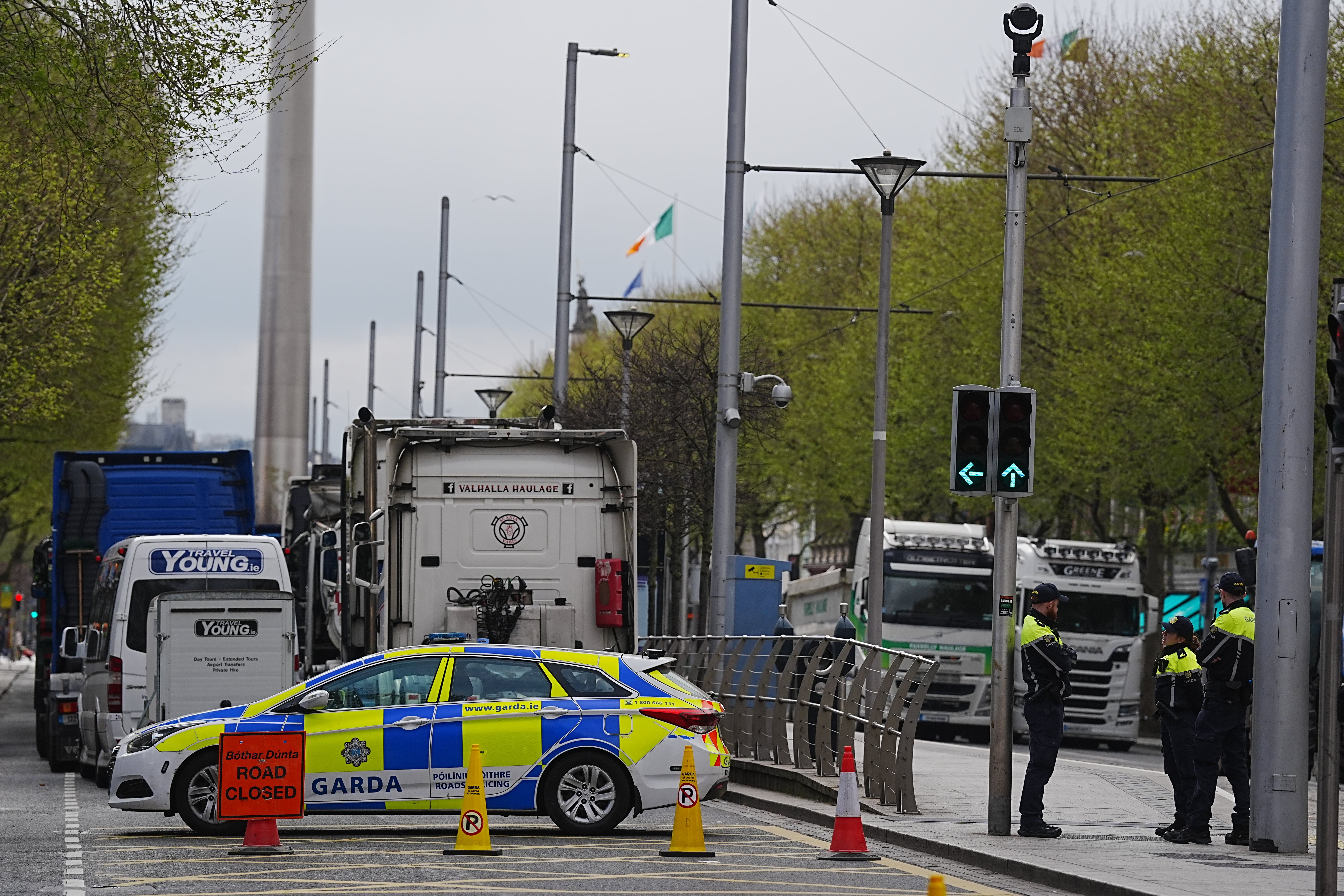 Garda next to vehicles parked on O’Connell Street (Brian Lawless/PA)