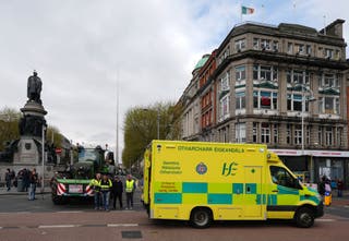 An ambulance drives past vehicles parked on O’Connell Street in Dublin (Brian Lawless/PA)