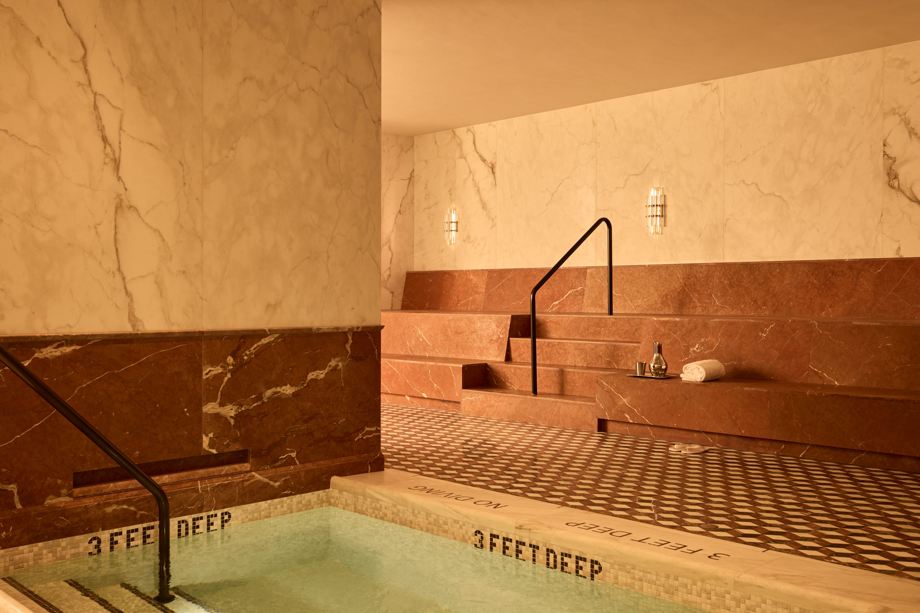 Bedrock Bathhouse features a marble bench beside its hot tub, accompanied by a sign enforcing a strict no-talking policy