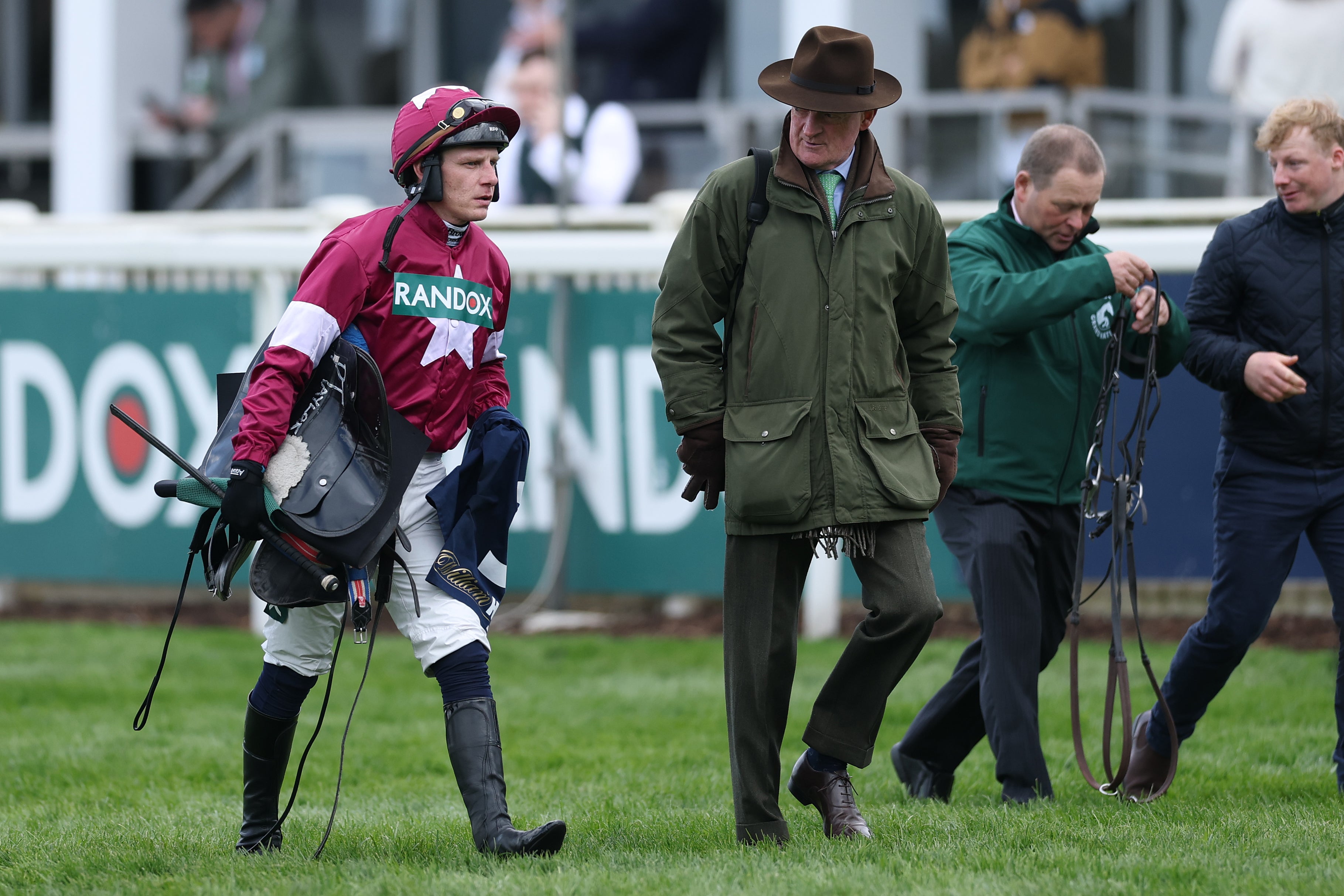 Paul Townend and trainer Willie Mullins walk from the course