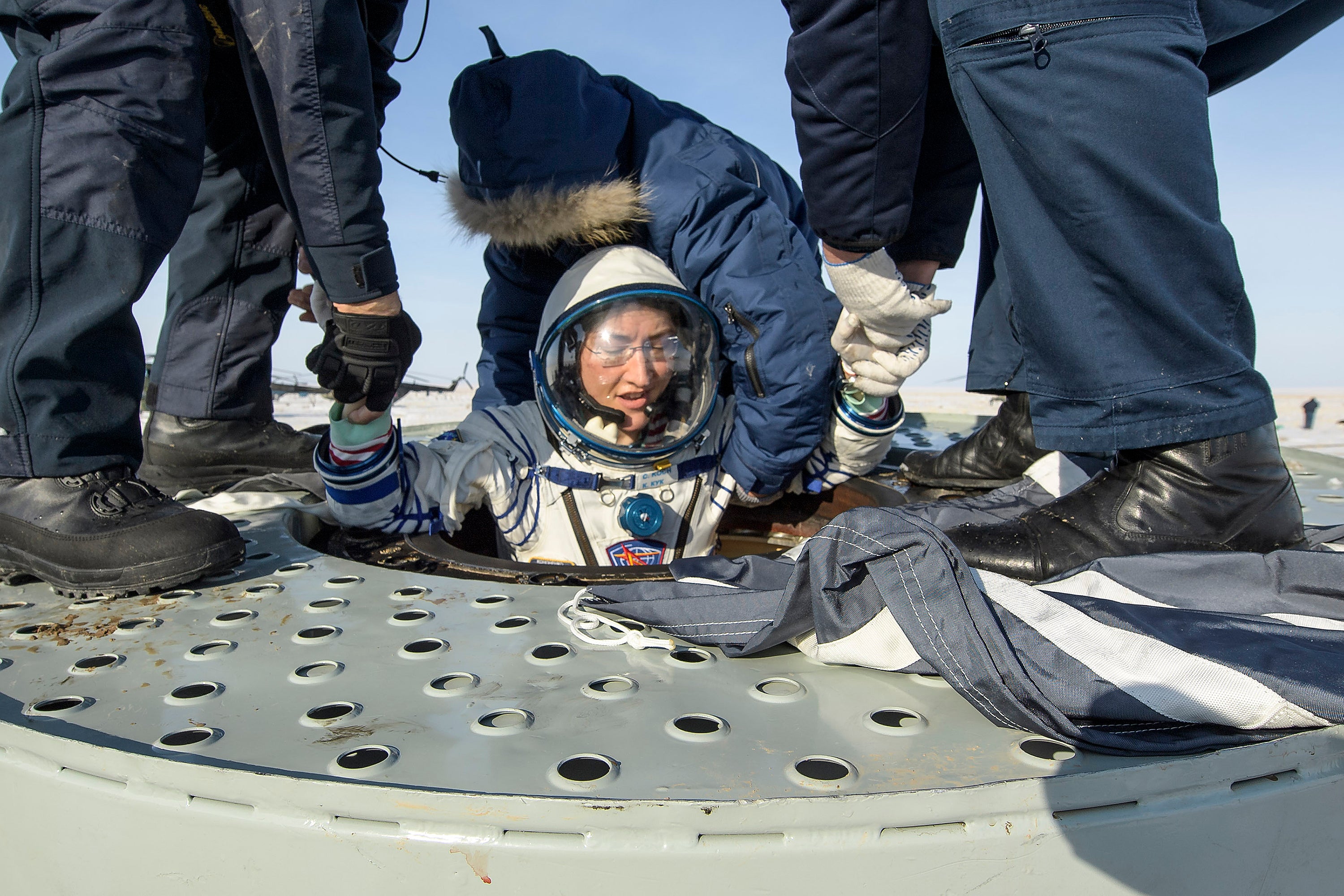 Koch is helped out of the Soyuz MS-13 spacecraft in Kazakhstan in February 2020