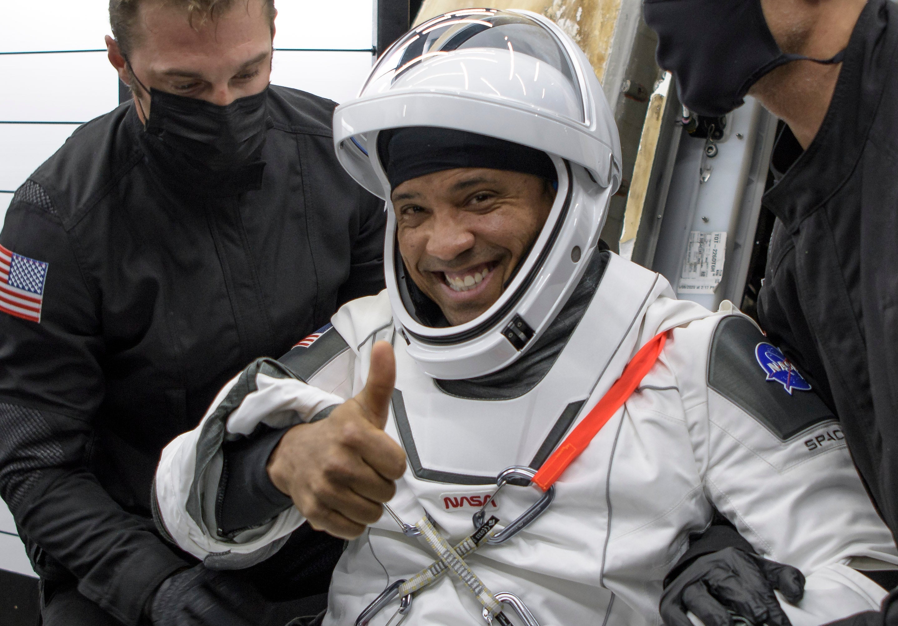 NASA astronaut Victor Glover is helped out of a SpaceX Crew Dragon Resilience spacecraft after a mission in May 2021. He later flew on the Artemis II mission
